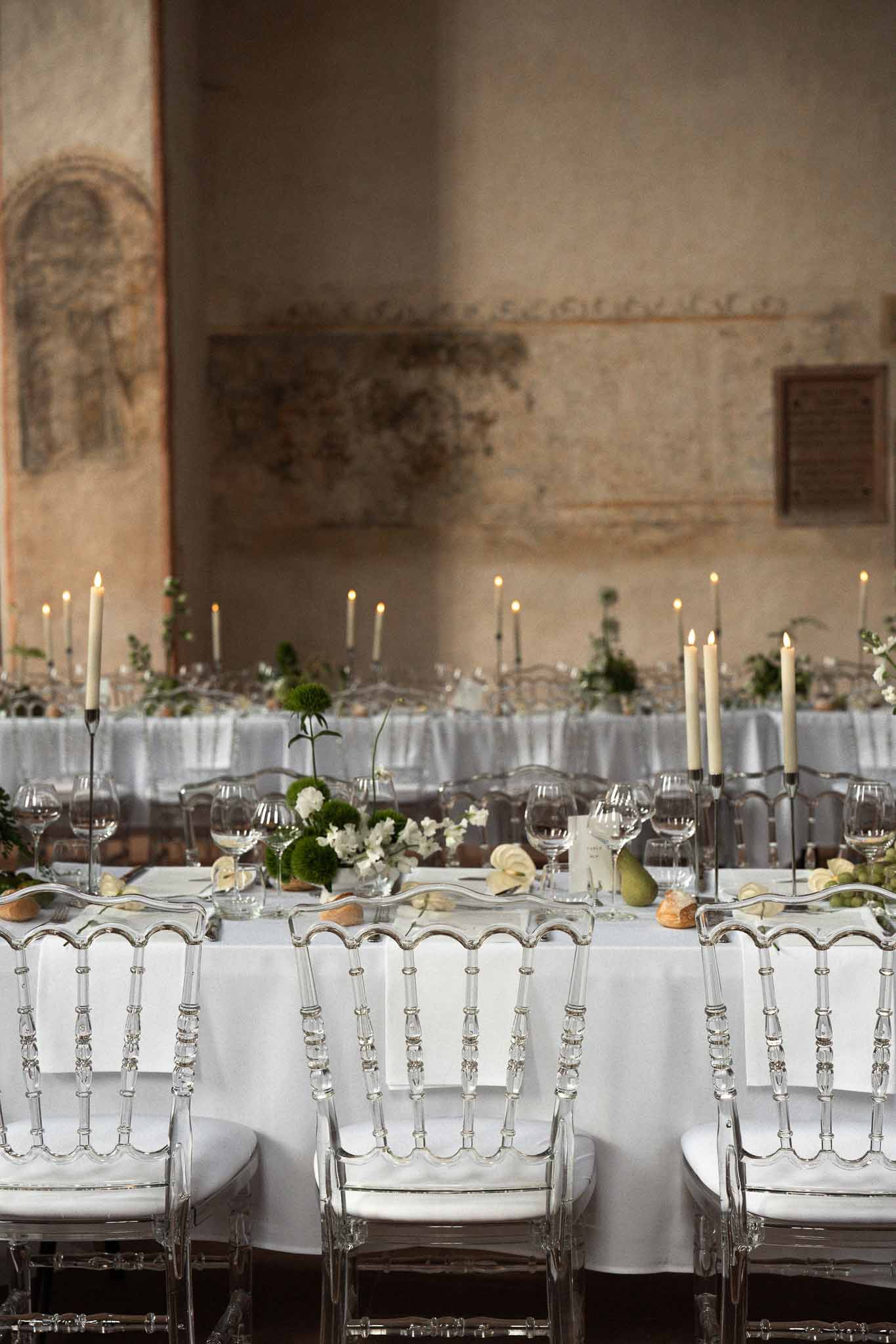 Wedding reception table setting in a chapel with white roses