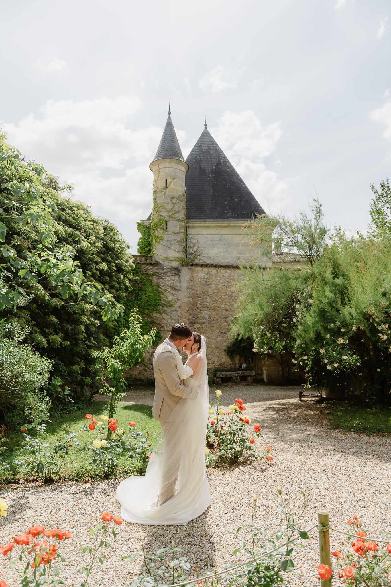 Bride and groom kissing in a garden