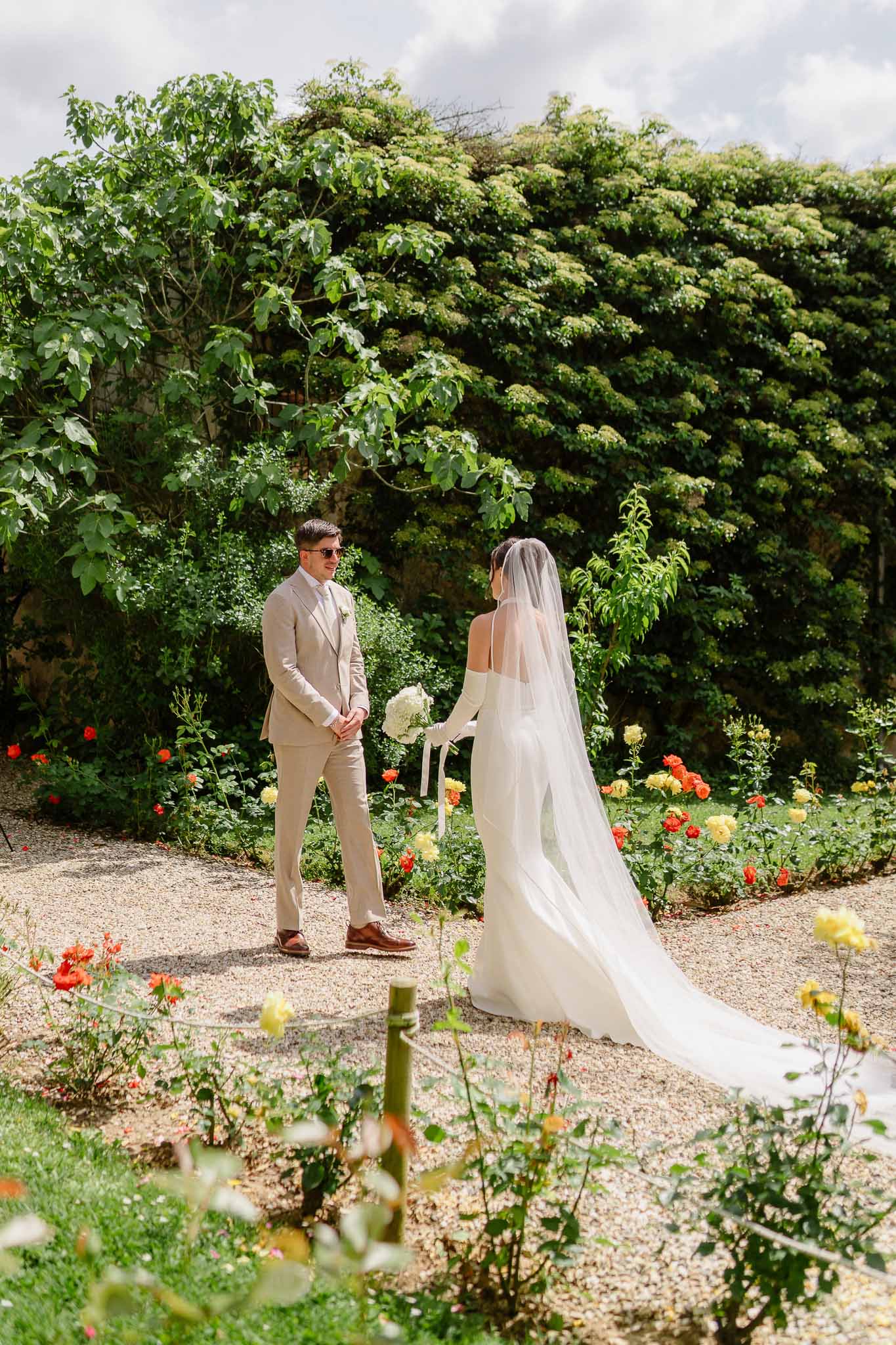 First look between bride and groom in a garden
