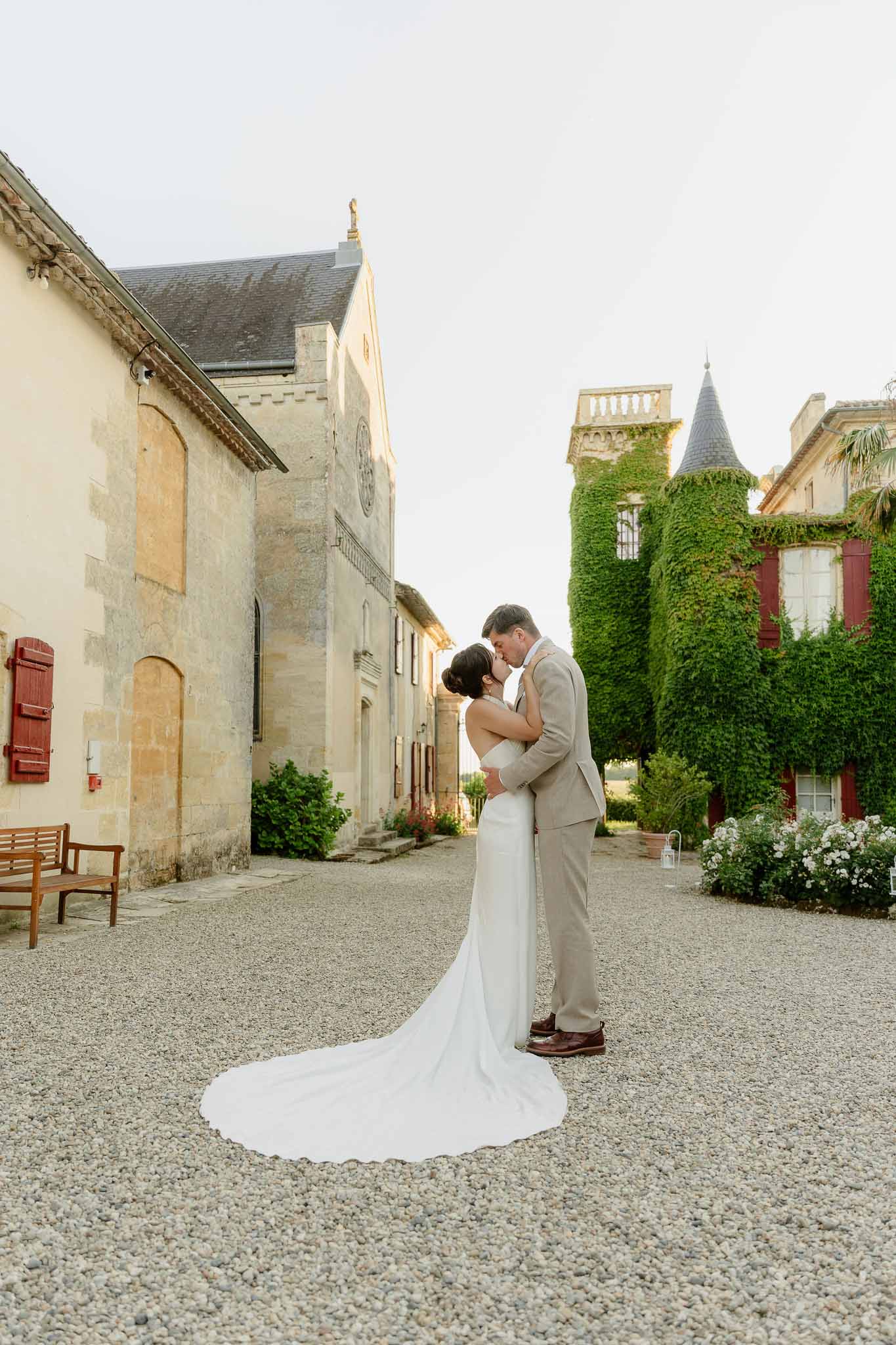 Bride and groom kissing in a chapel