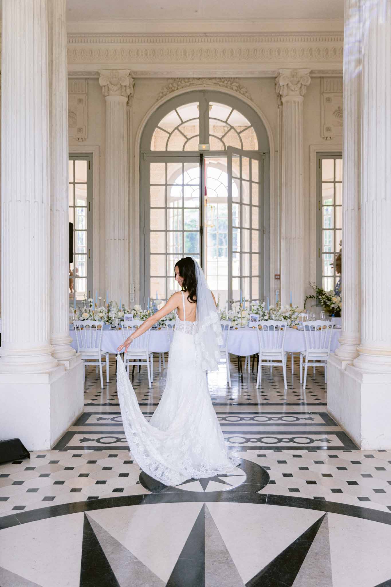 Black and white photo of wedding reception table setting with white roses