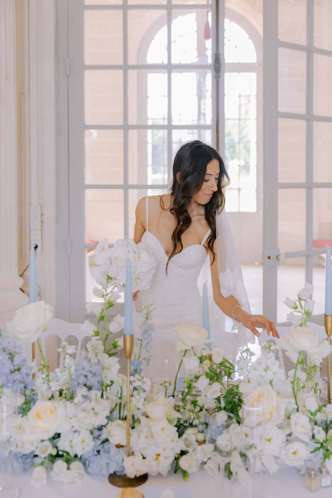 Wedding reception table setting in a garden with white roses