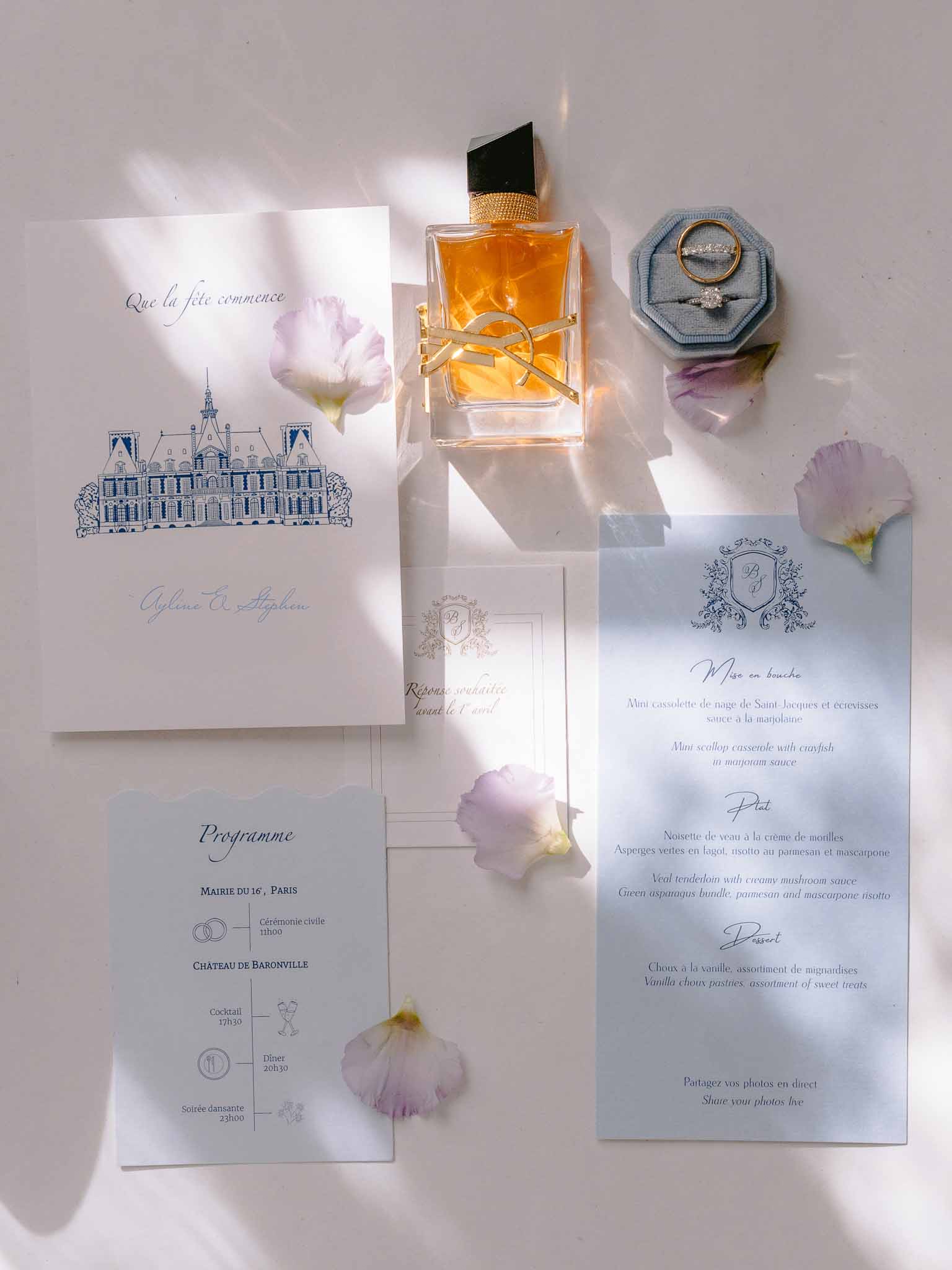 French wedding stationery suite with chateau illustration, blue programme card, YSL perfume, and velvet ring box