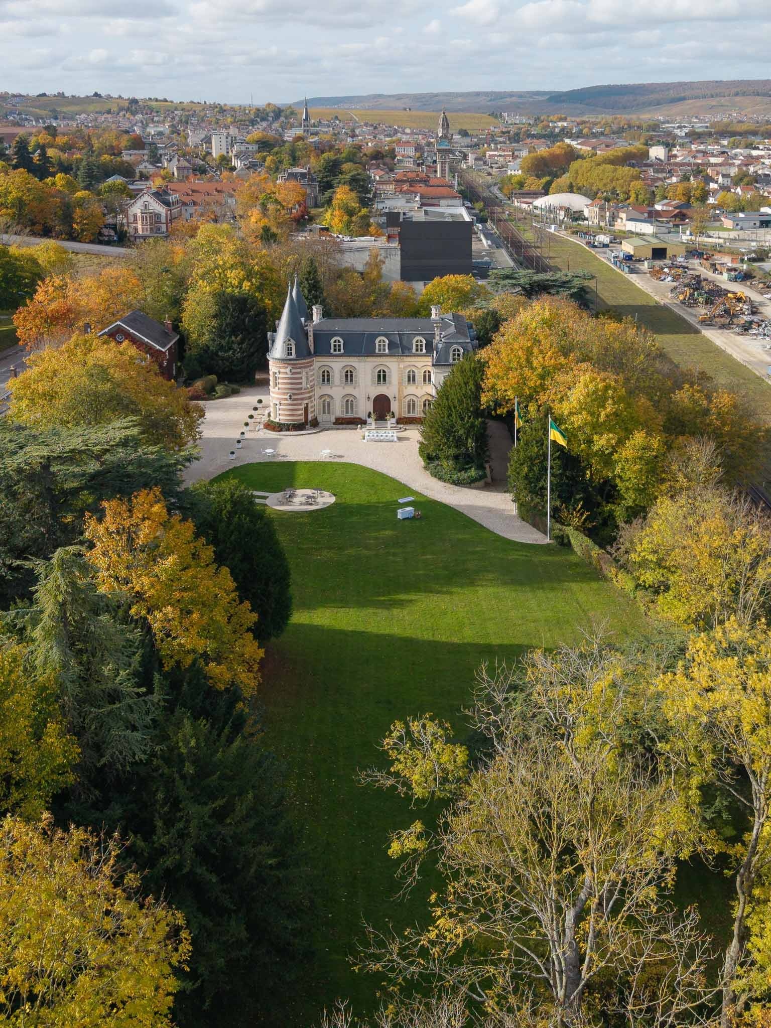 Aerial drone view of Château Comtesse Lafond with autumn trees in Épernay