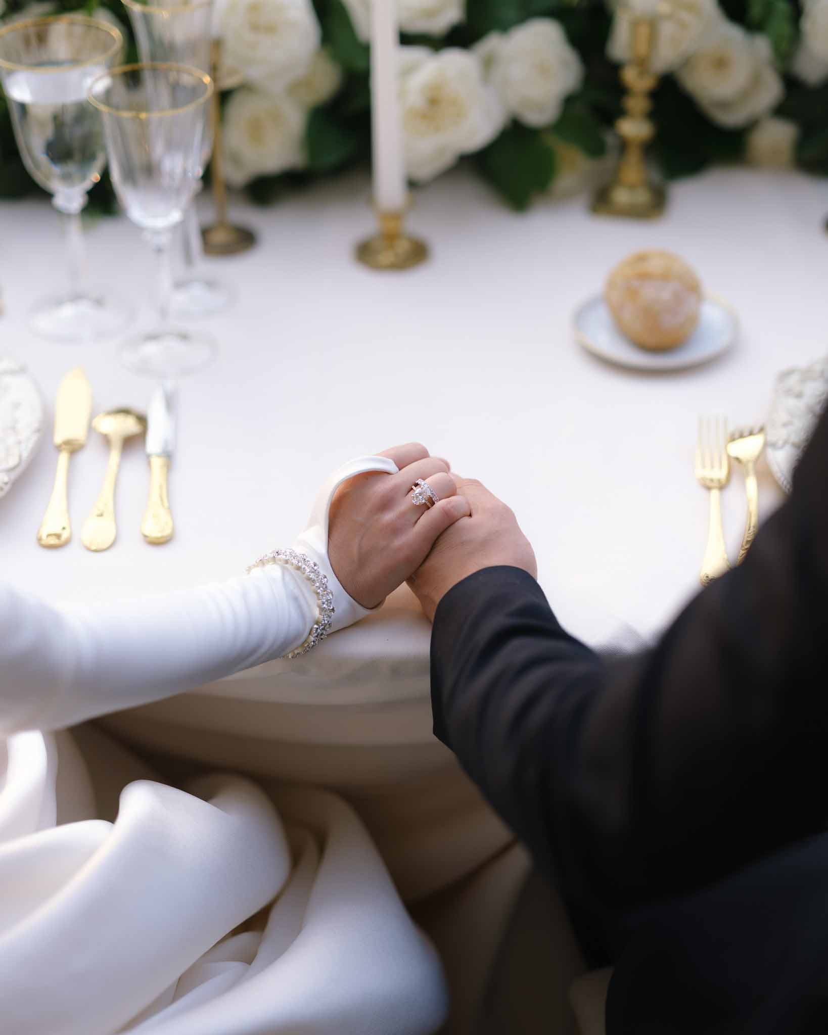Wedding reception table setting in a garden with white roses