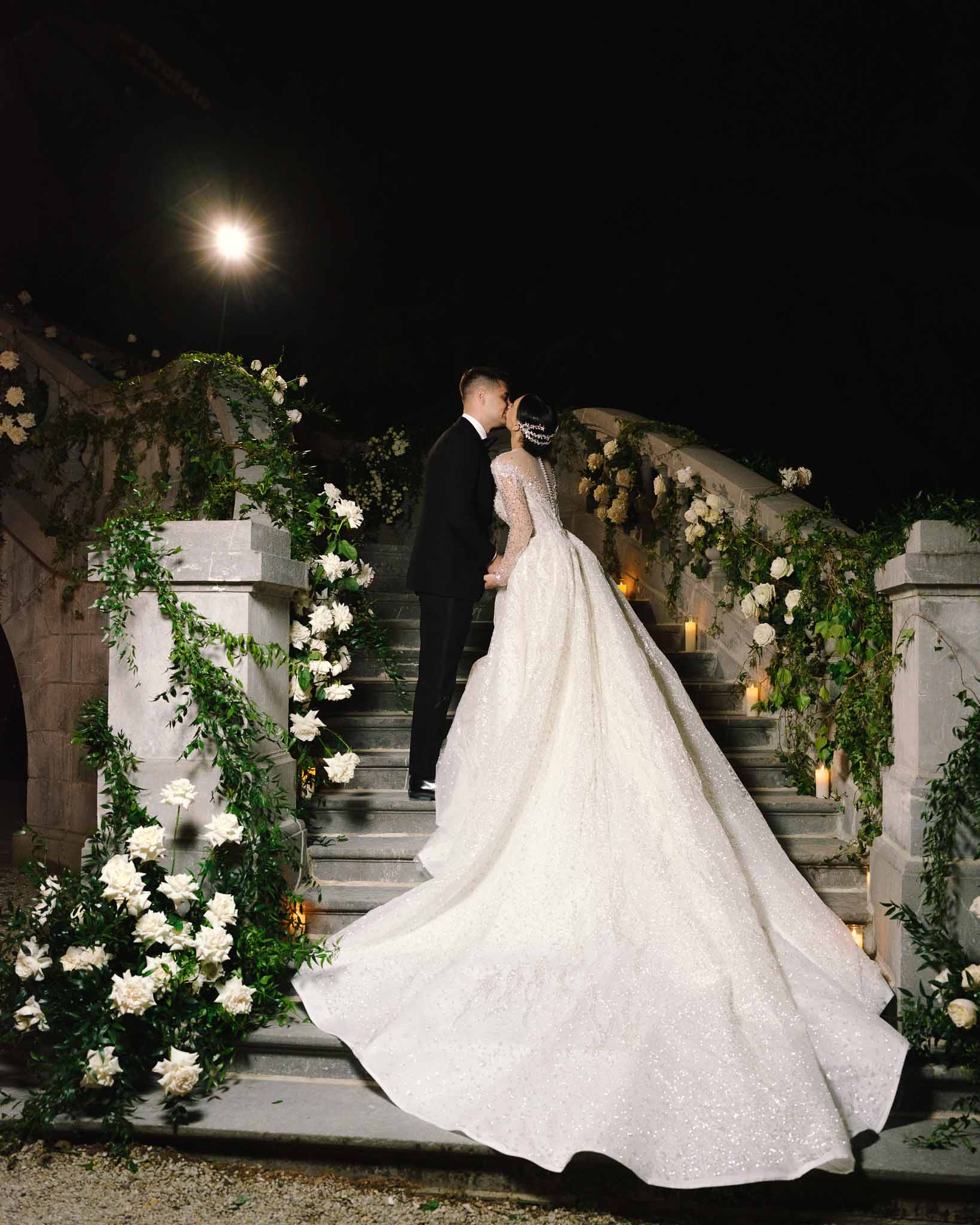Bride and groom kissing in a garden