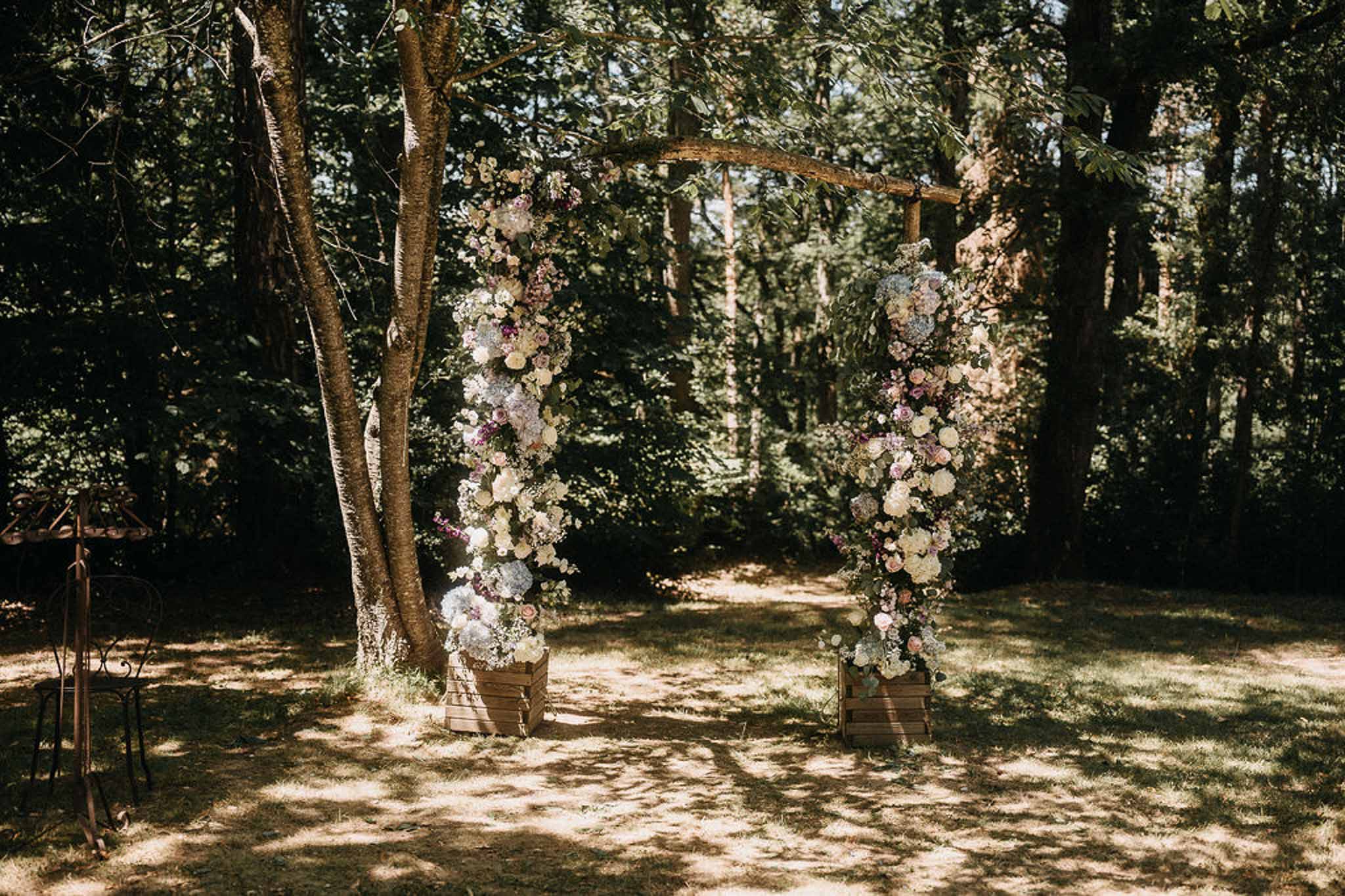 Wedding ceremony setup in a garden with white roses