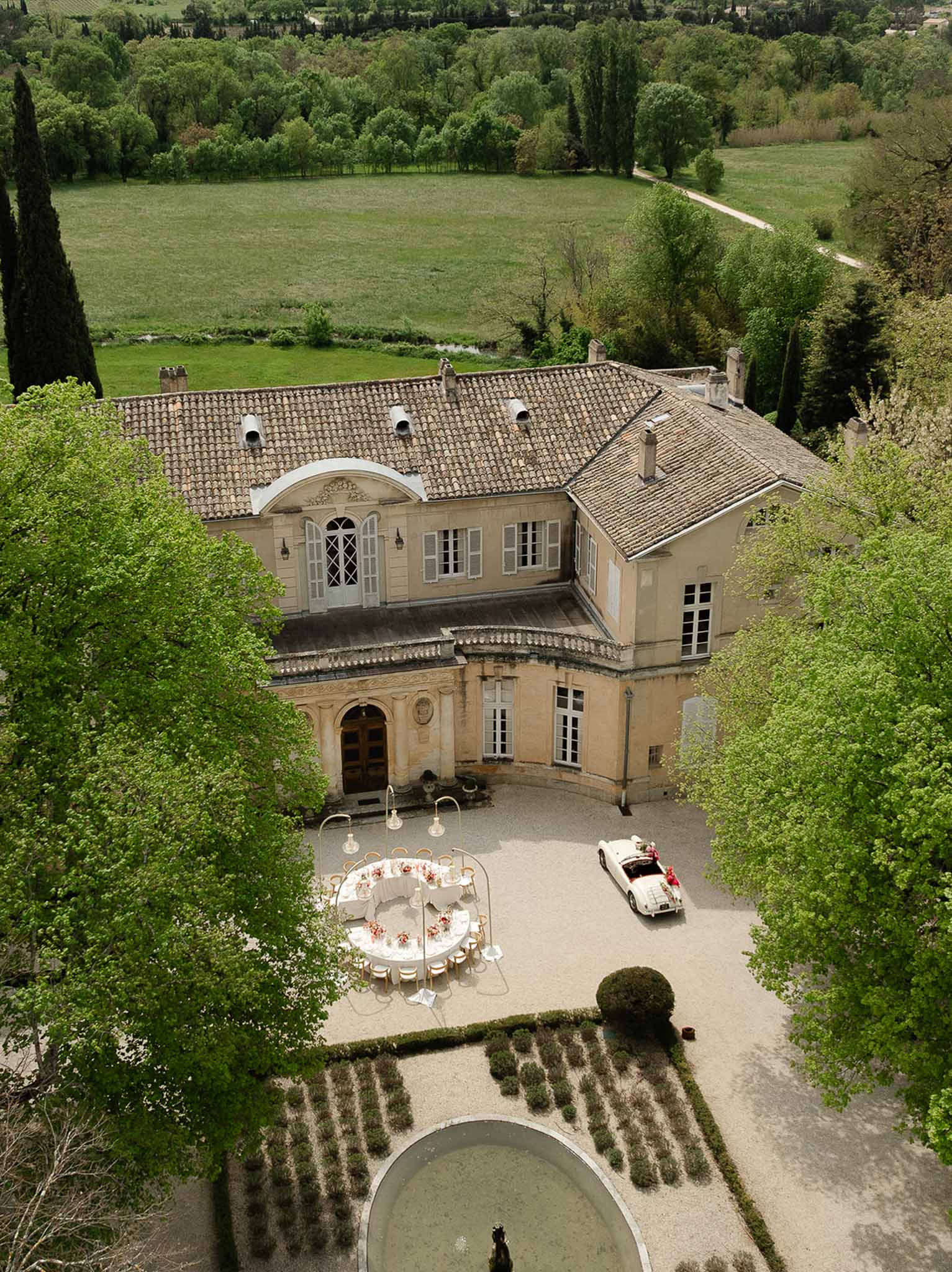 Aerial view of Château Martinay garden fountain and reception setup