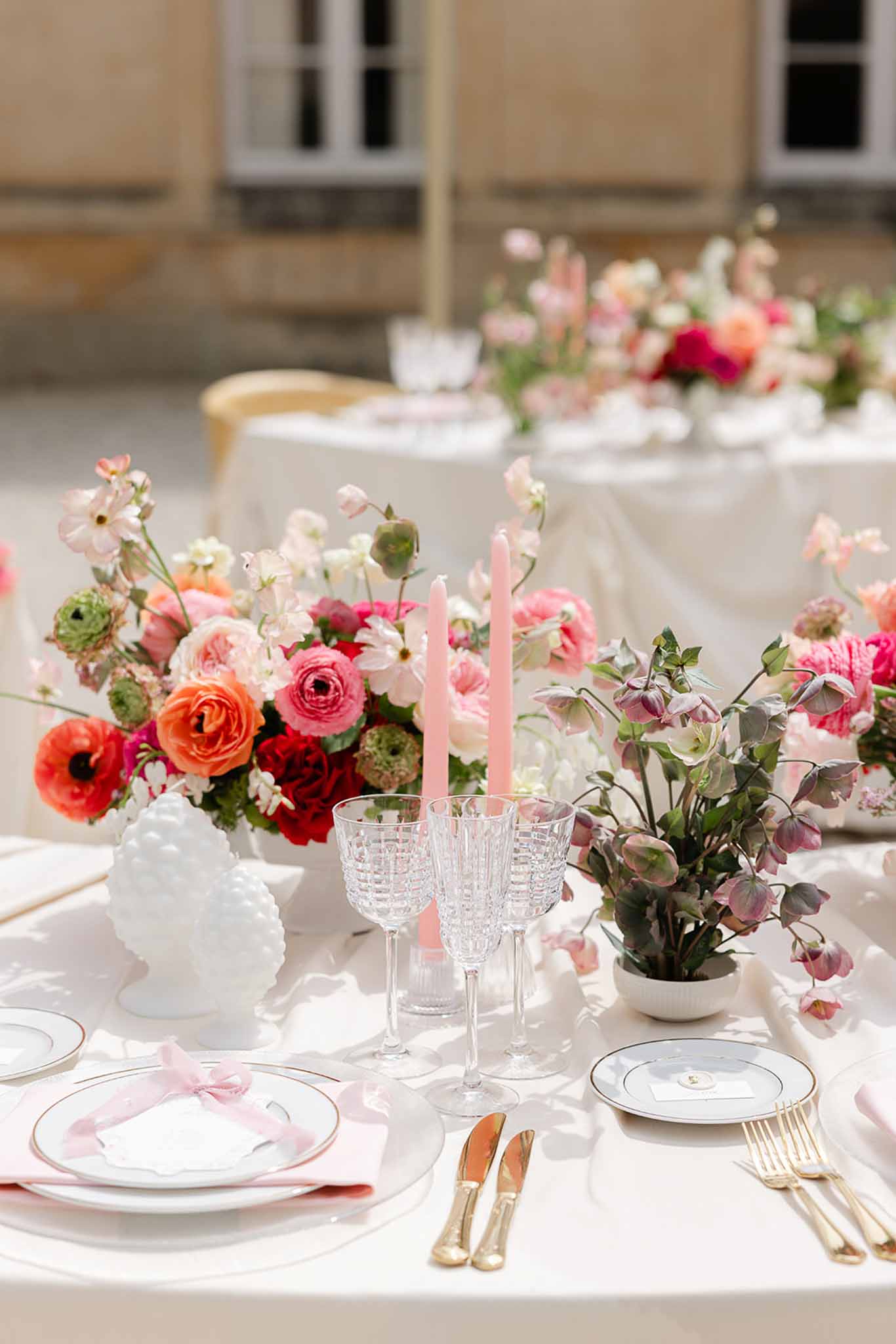 Pink flower and candle centrepiece at Château Martinay reception table