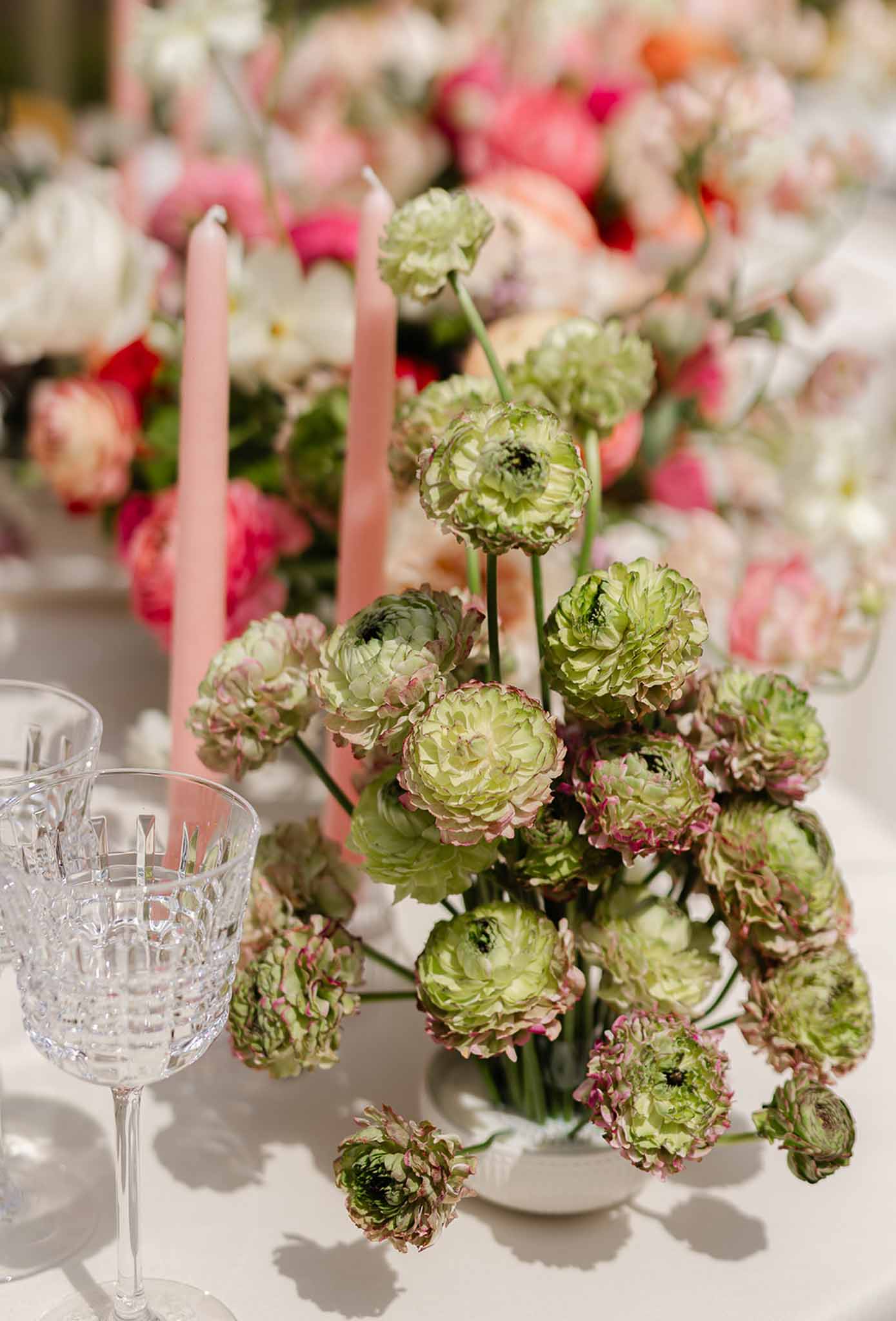 Floral centrepiece with candles and crystal glassware at Château Martinay