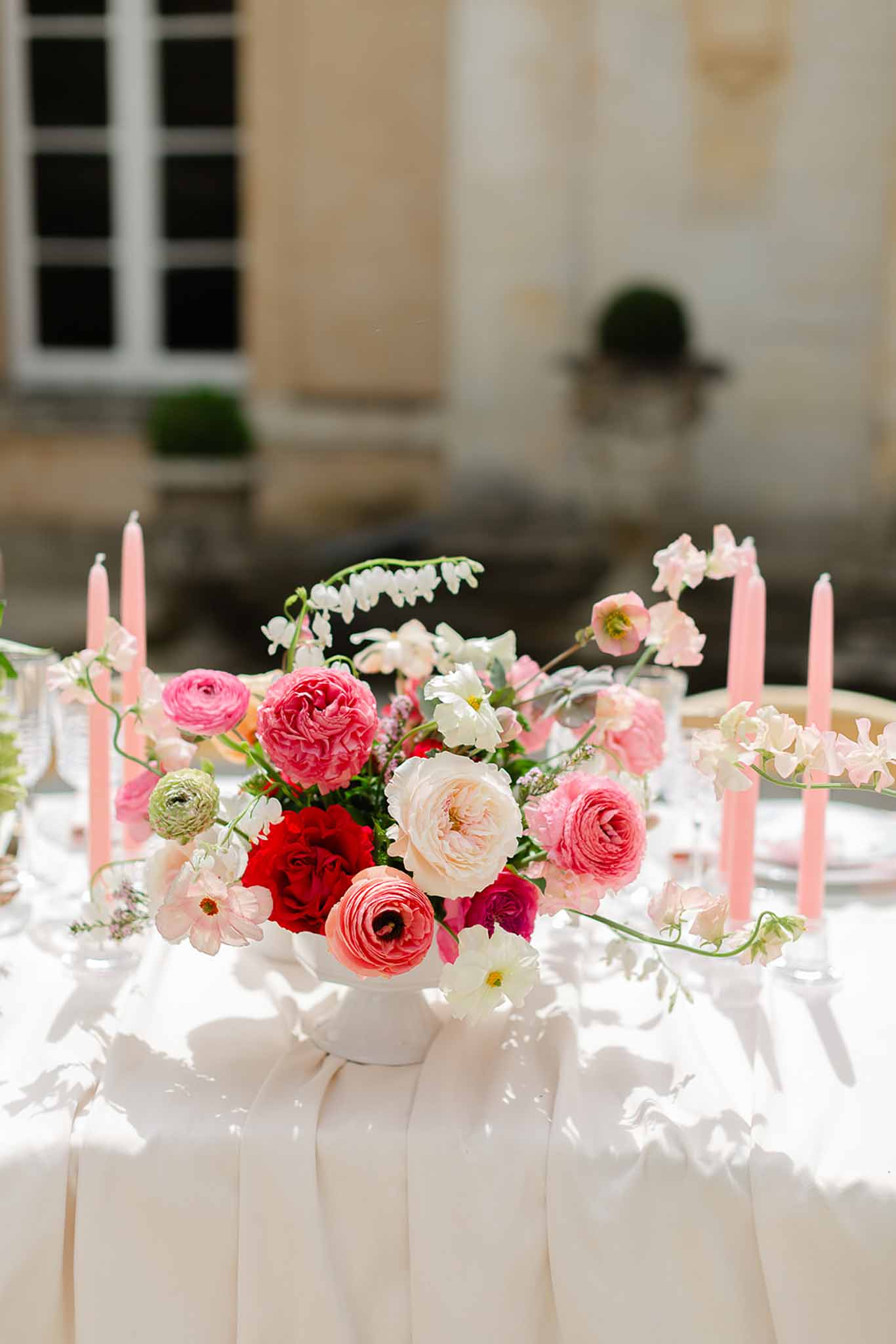 White vase with flower centrepiece at Château Martinay reception table