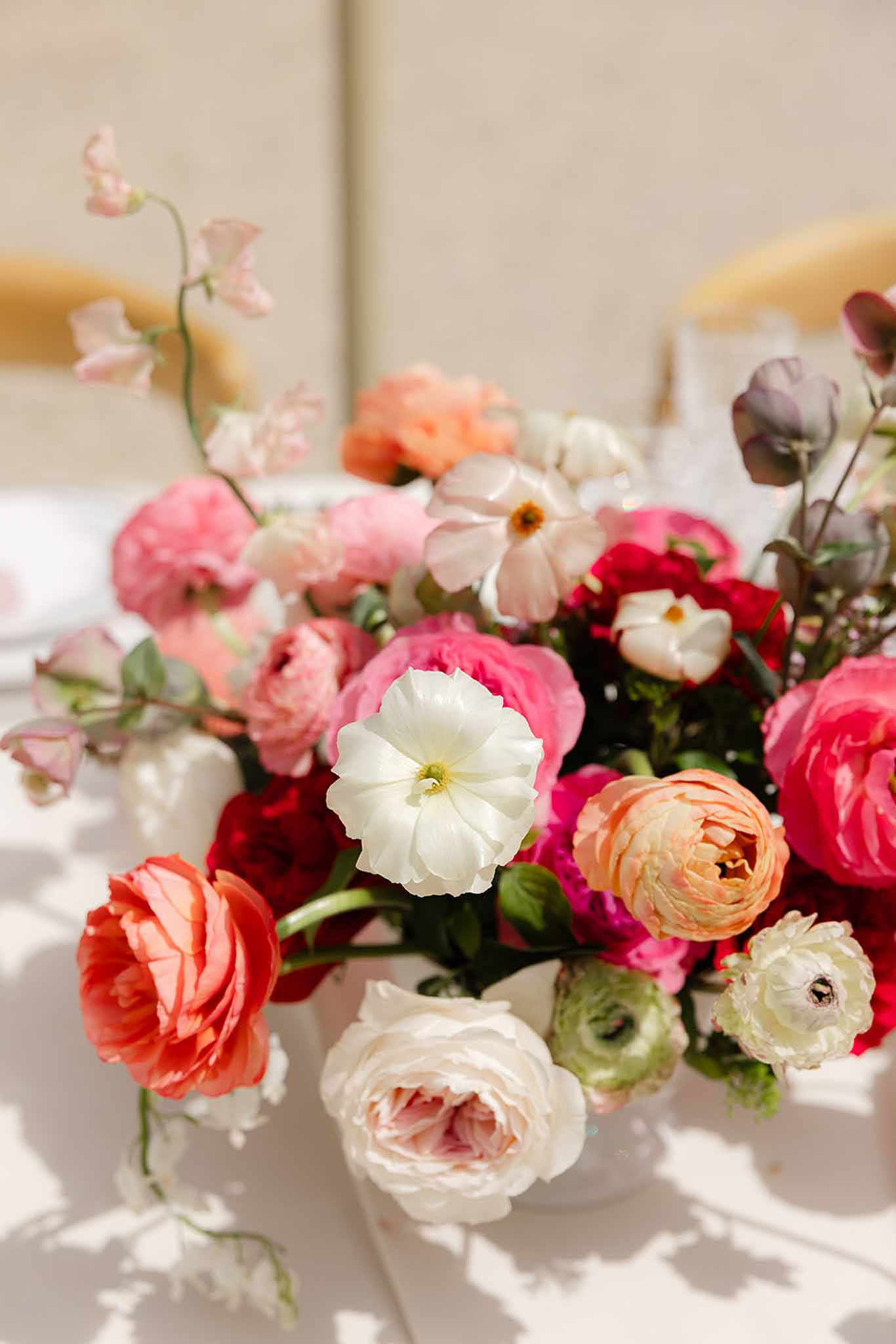 White, pink, and deep red flower centrepiece at Château Martinay styled shoot