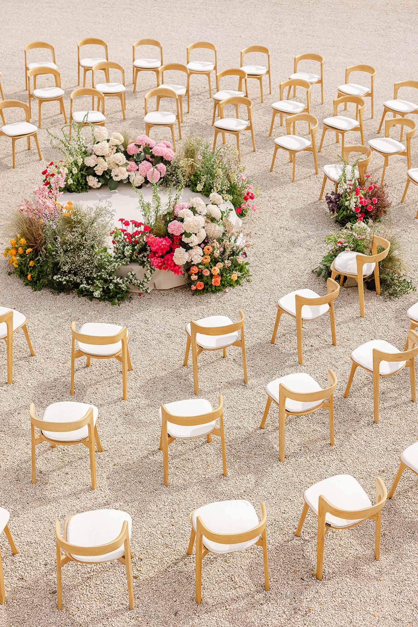 Floral arch and chairs at circular ceremony altar, Château Martinay