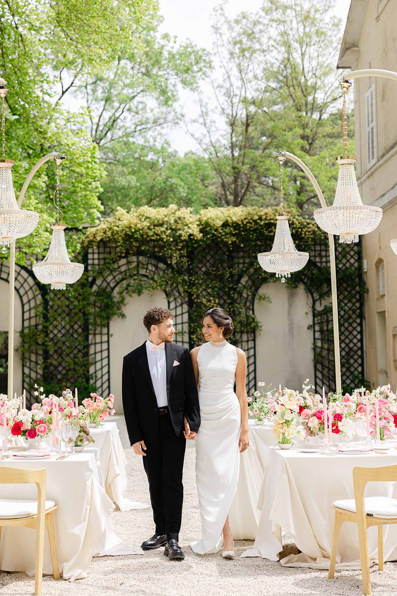Bride and groom walking through reception area at Château Martinay
