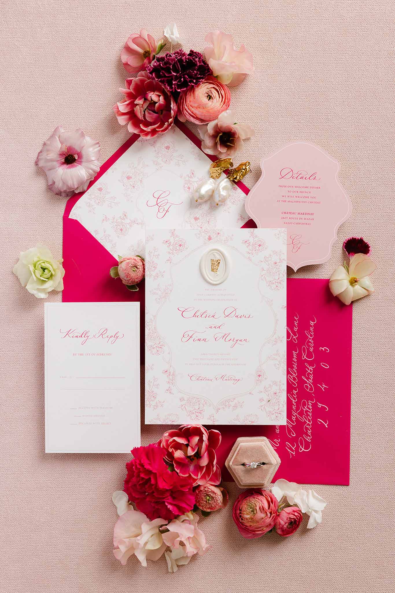 Flat lay of pink invitation suite with florals, Château Martinay styled shoot