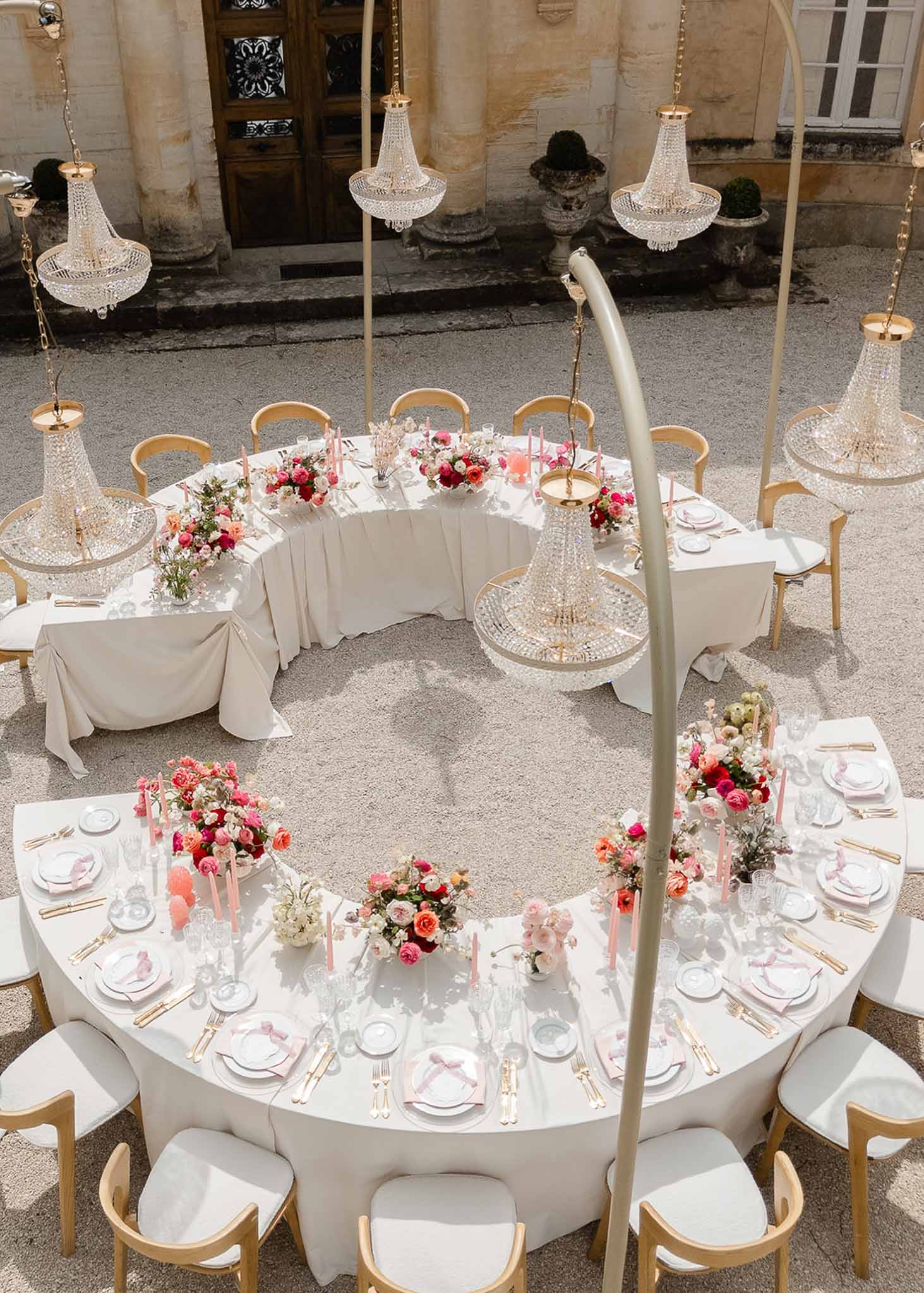 Gold and ivory tablescape with crystal chandeliers at Château Martinay reception