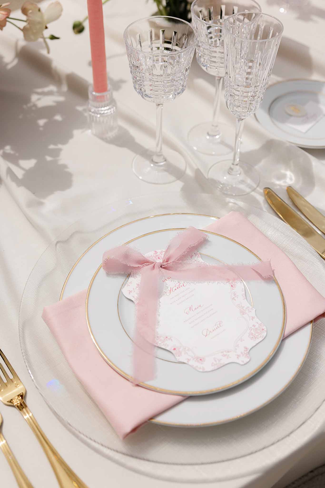 Pink and gold menu card on gold tableware at Château Martinay styled shoot