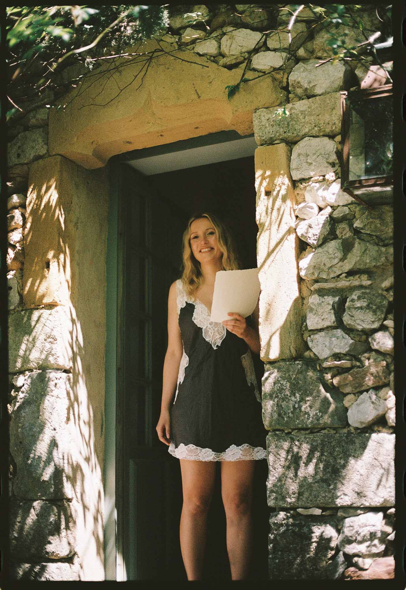 Bride reading handwritten vows while getting ready at Chateau St Victor Lacoste