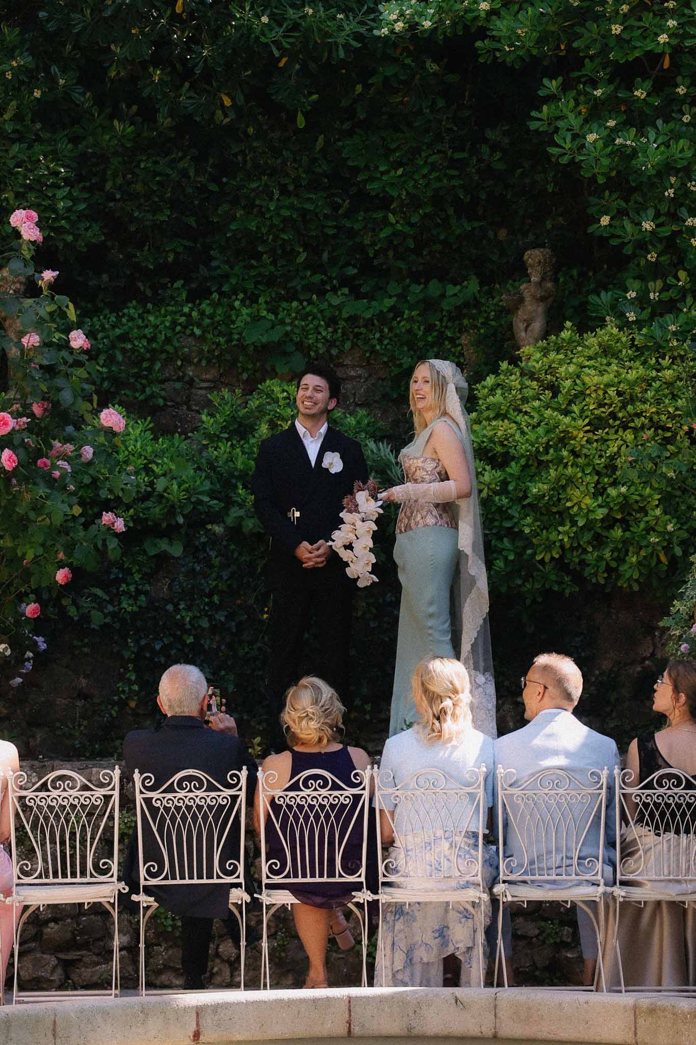 Bride and groom at altar with seated guests at Chateau St Victor Lacoste ceremony
