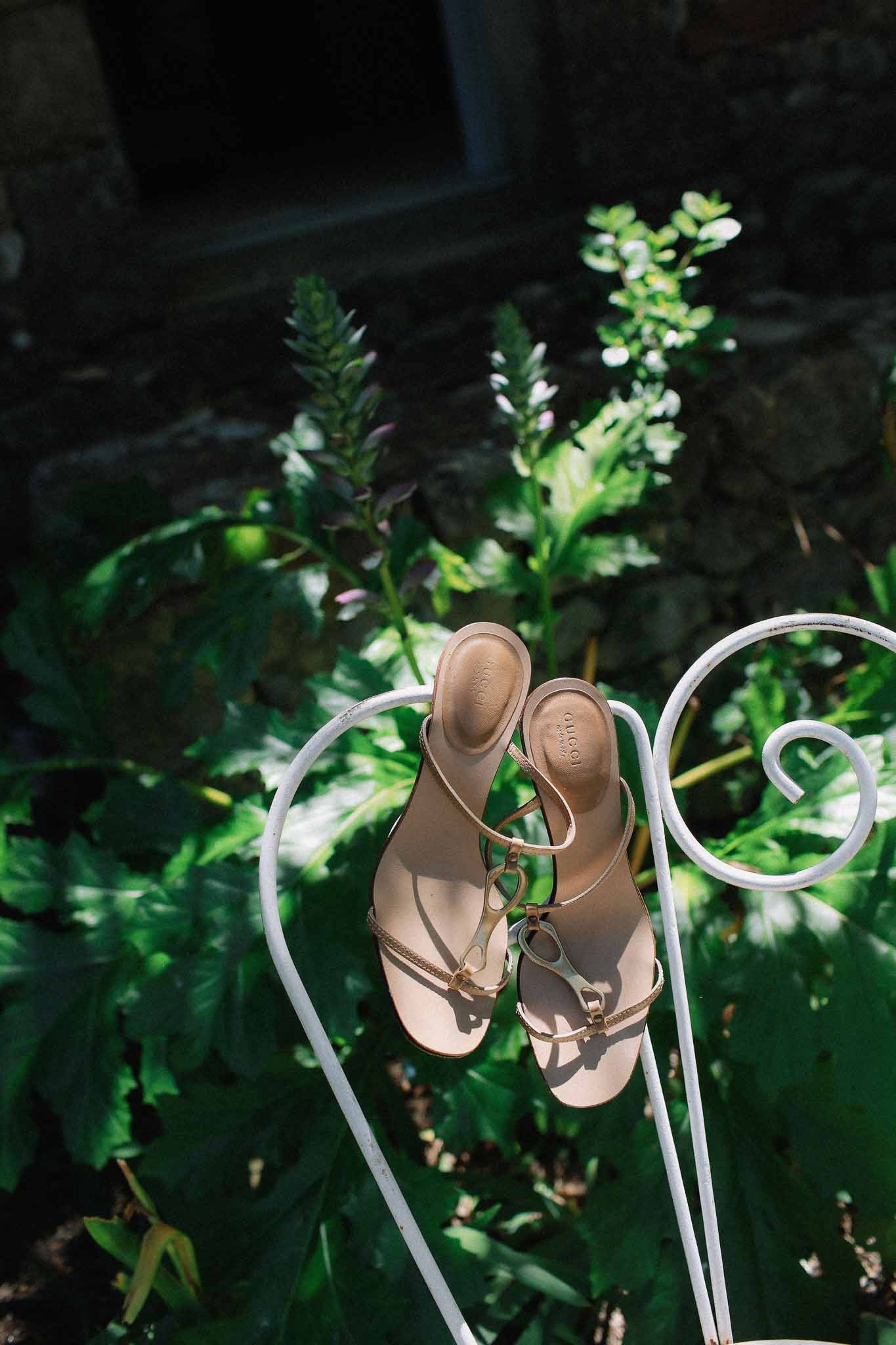 Bridal shoes hanging from vintage chair at Chateau St Victor Lacoste