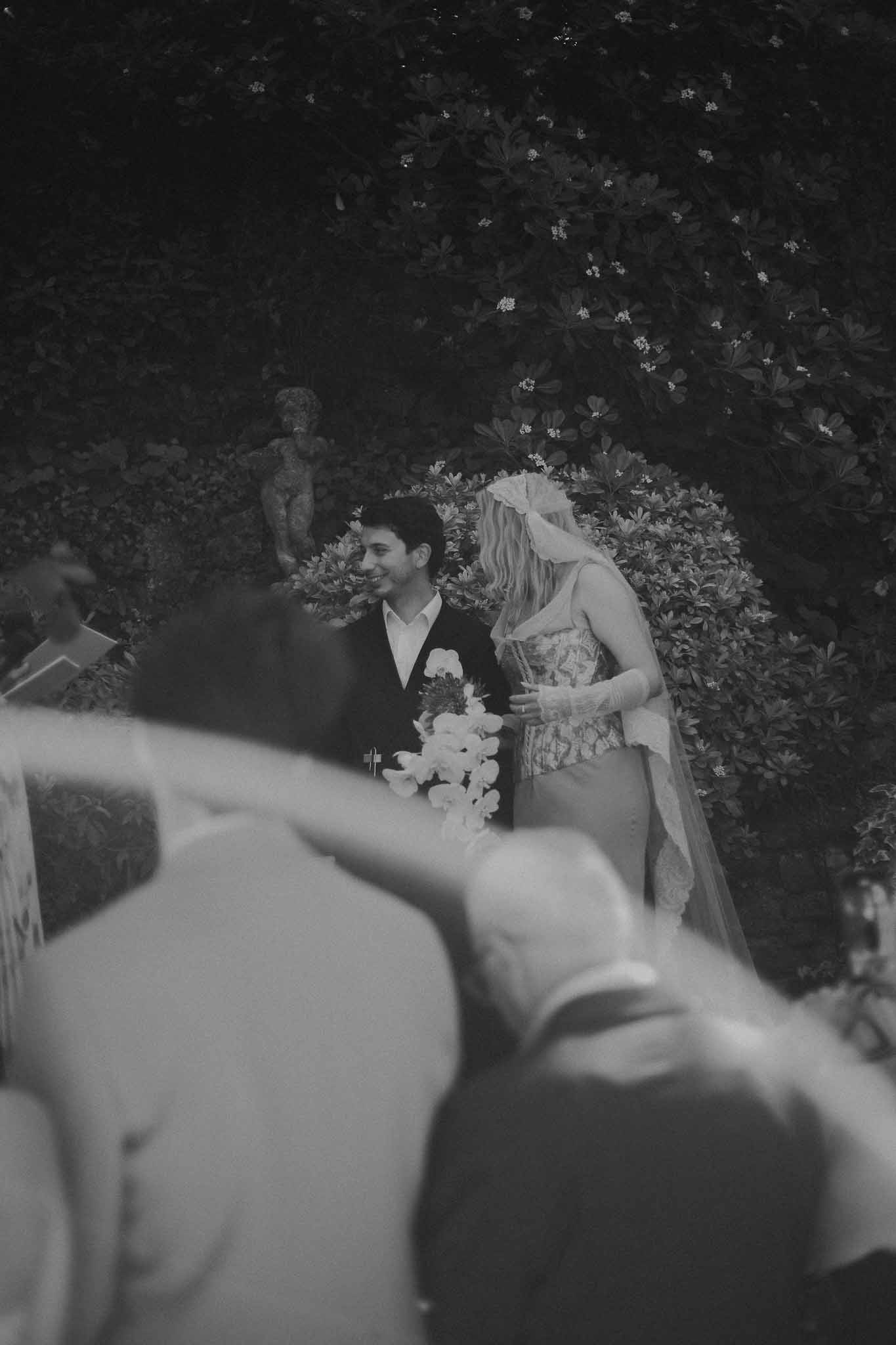 Jenni and Federico holding hands at the altar during their wedding ceremony