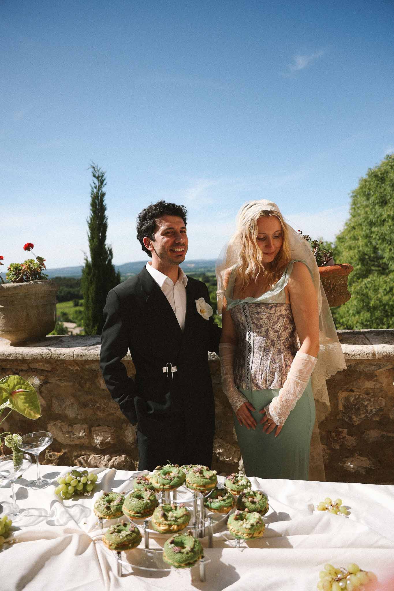 Couple at the cake table during reception at Chateau St Victor Lacoste
