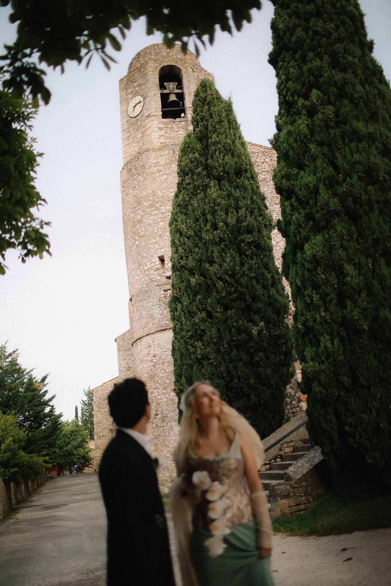 Couple posing with chateau tower visible in background at Chateau St Victor Lacoste