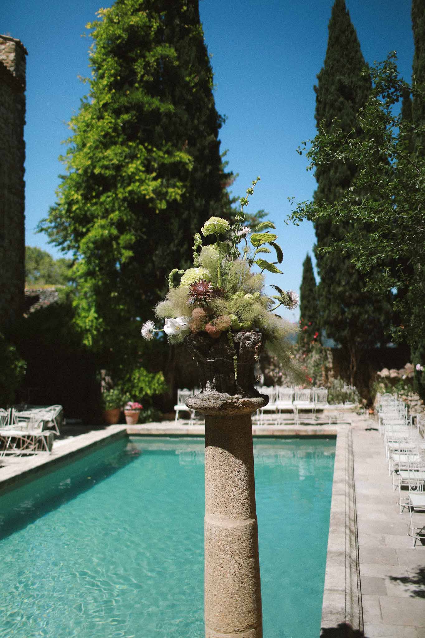 Floral decorations at poolside ceremony area at Chateau St Victor Lacoste