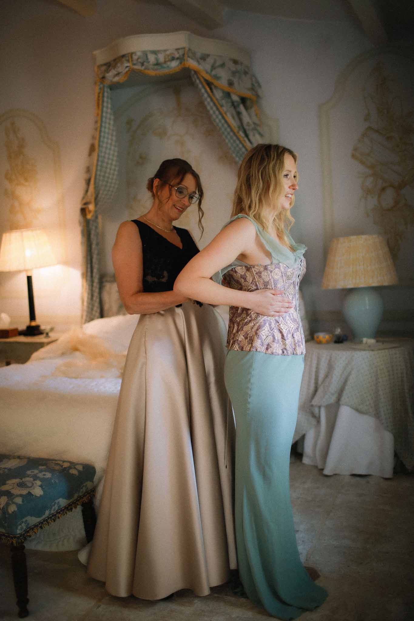 Bride standing in vintage bedroom at Chateau St Victor Lacoste