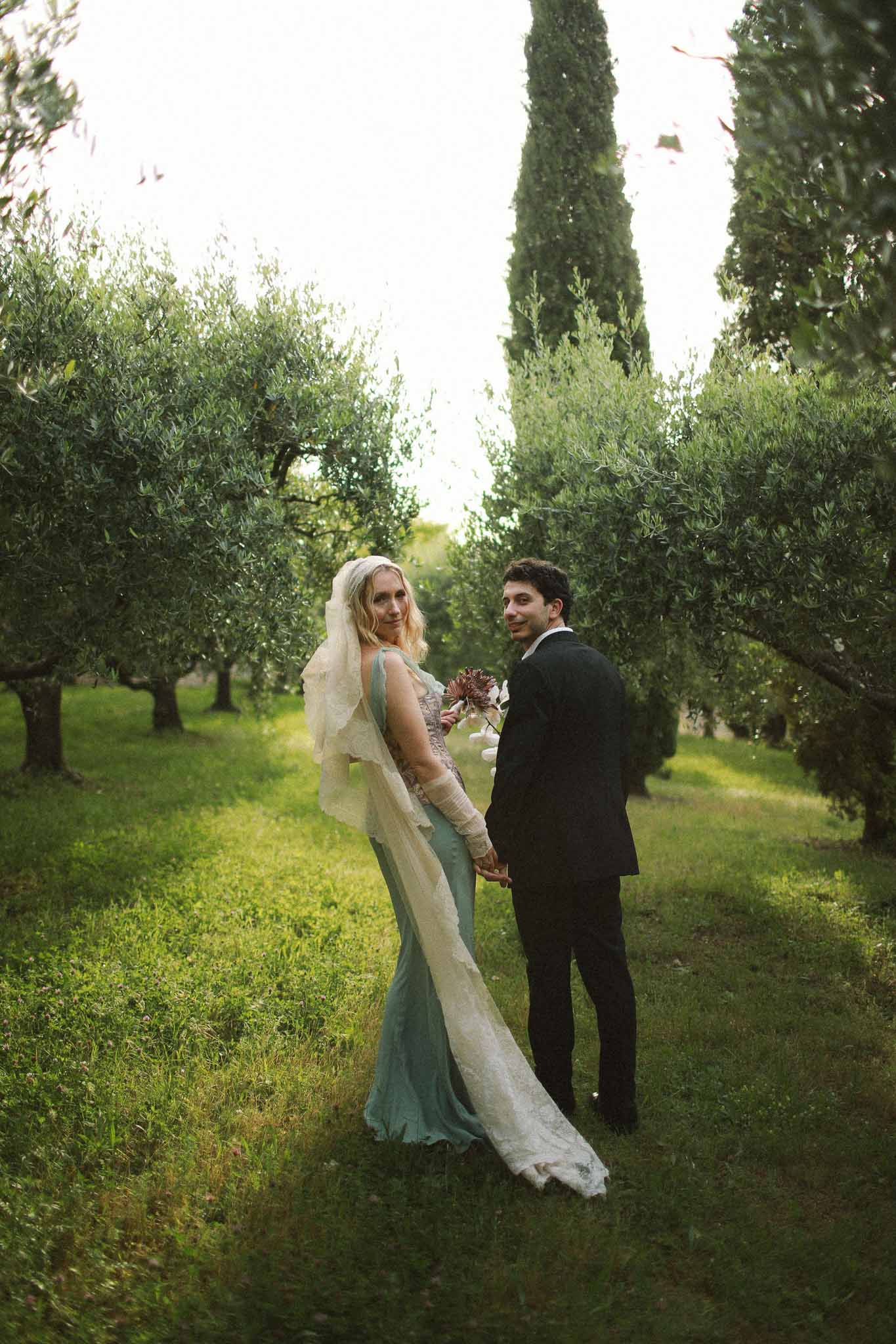 Back view of couple walking at golden hour at Chateau St Victor Lacoste
