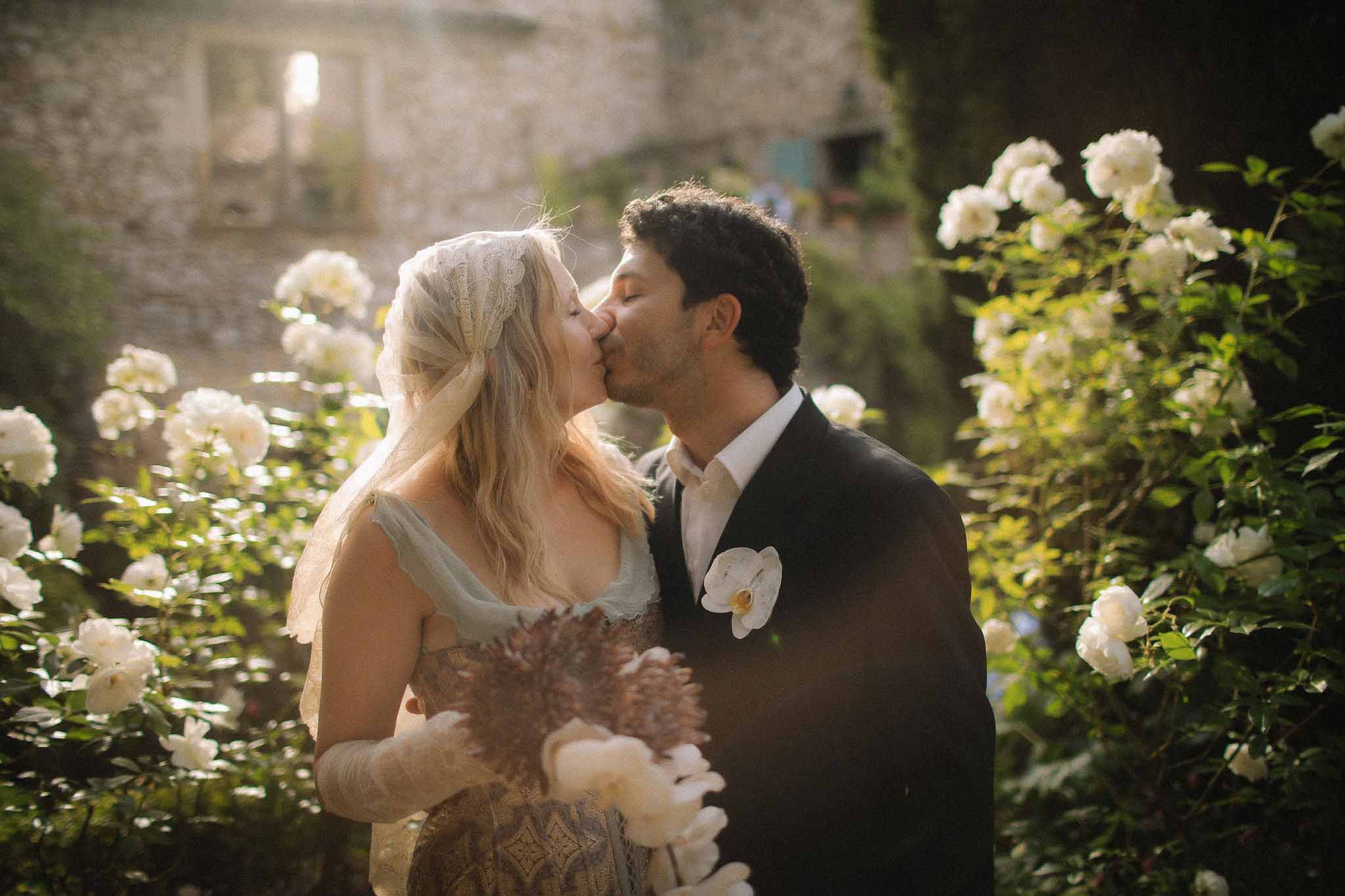 Close-up of Jenni and Federico kissing at golden hour at Chateau St Victor Lacoste
