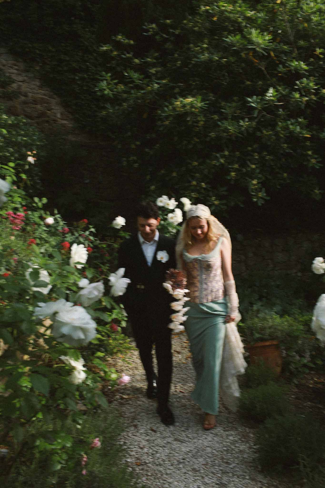 Couple walking through garden at sunset at Chateau St Victor Lacoste