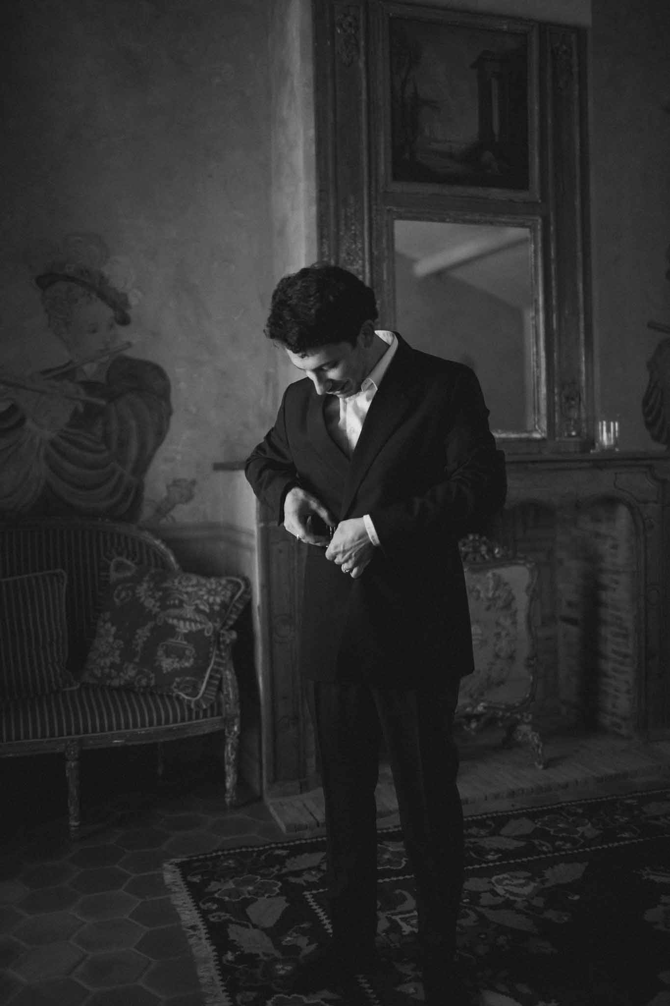 Groom wearing tuxedo outdoors at Chateau St Victor Lacoste