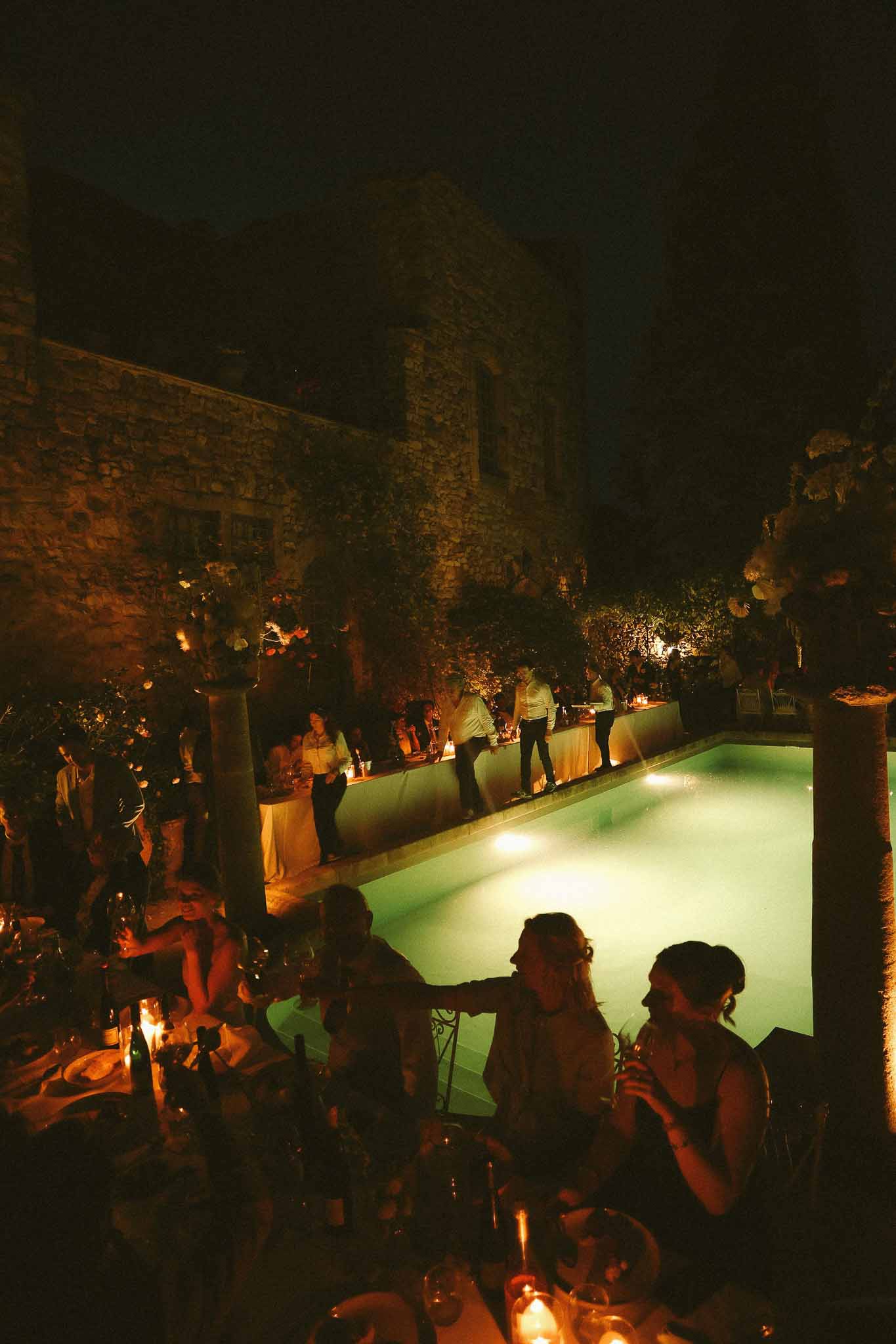 Evening dinner scene beside the pool at Chateau St Victor Lacoste