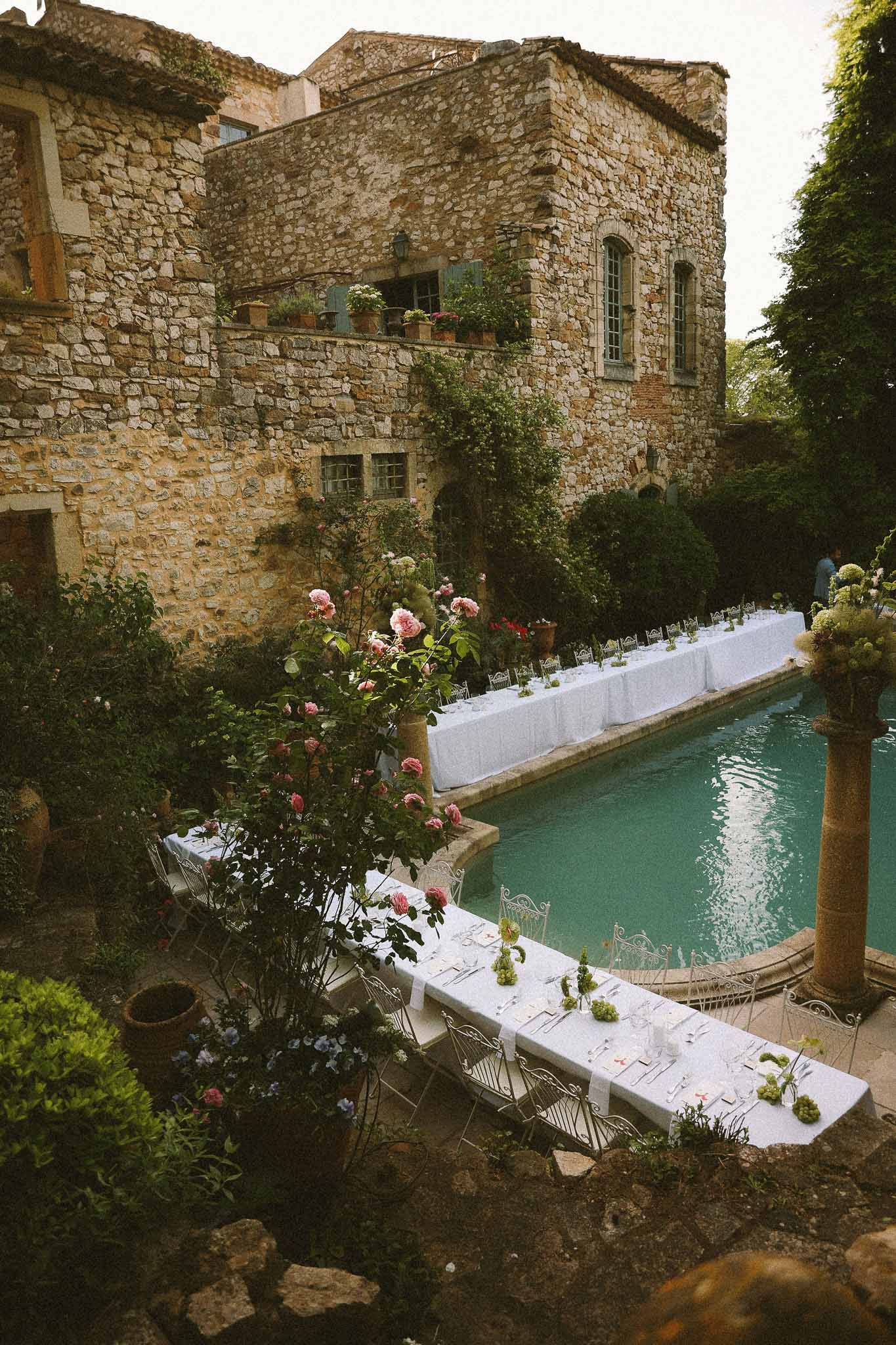 Vintage-style reception table setting poolside at Chateau St Victor Lacoste