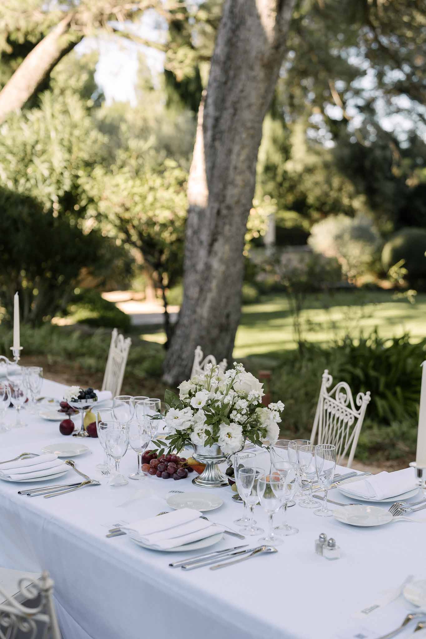 Wedding reception table setting in a garden with peonies