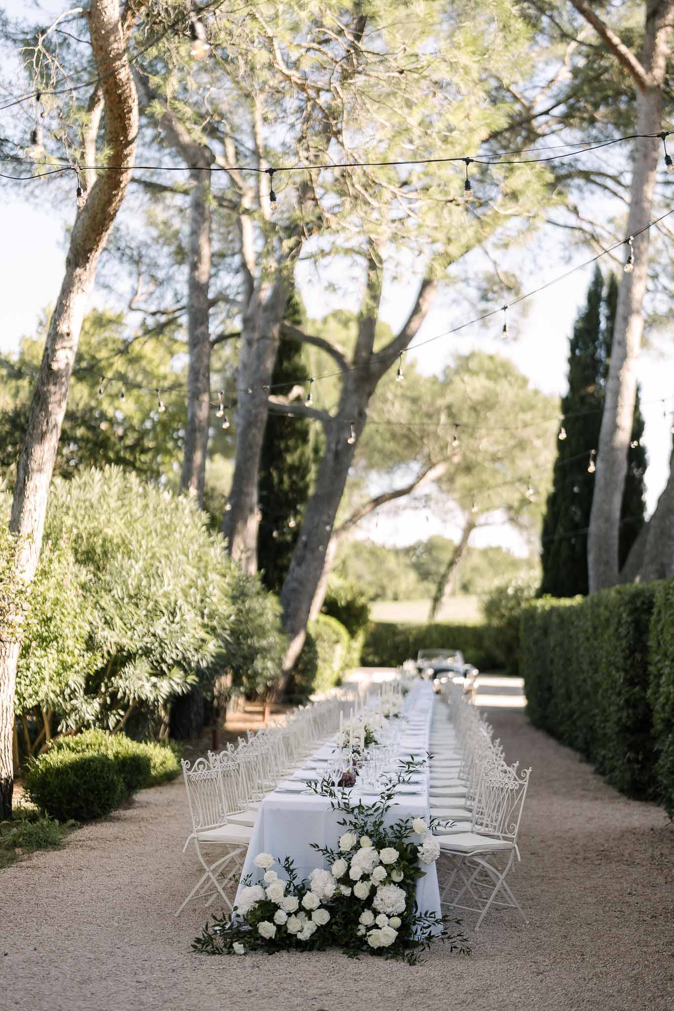 Wedding reception table setting in a garden with peonies