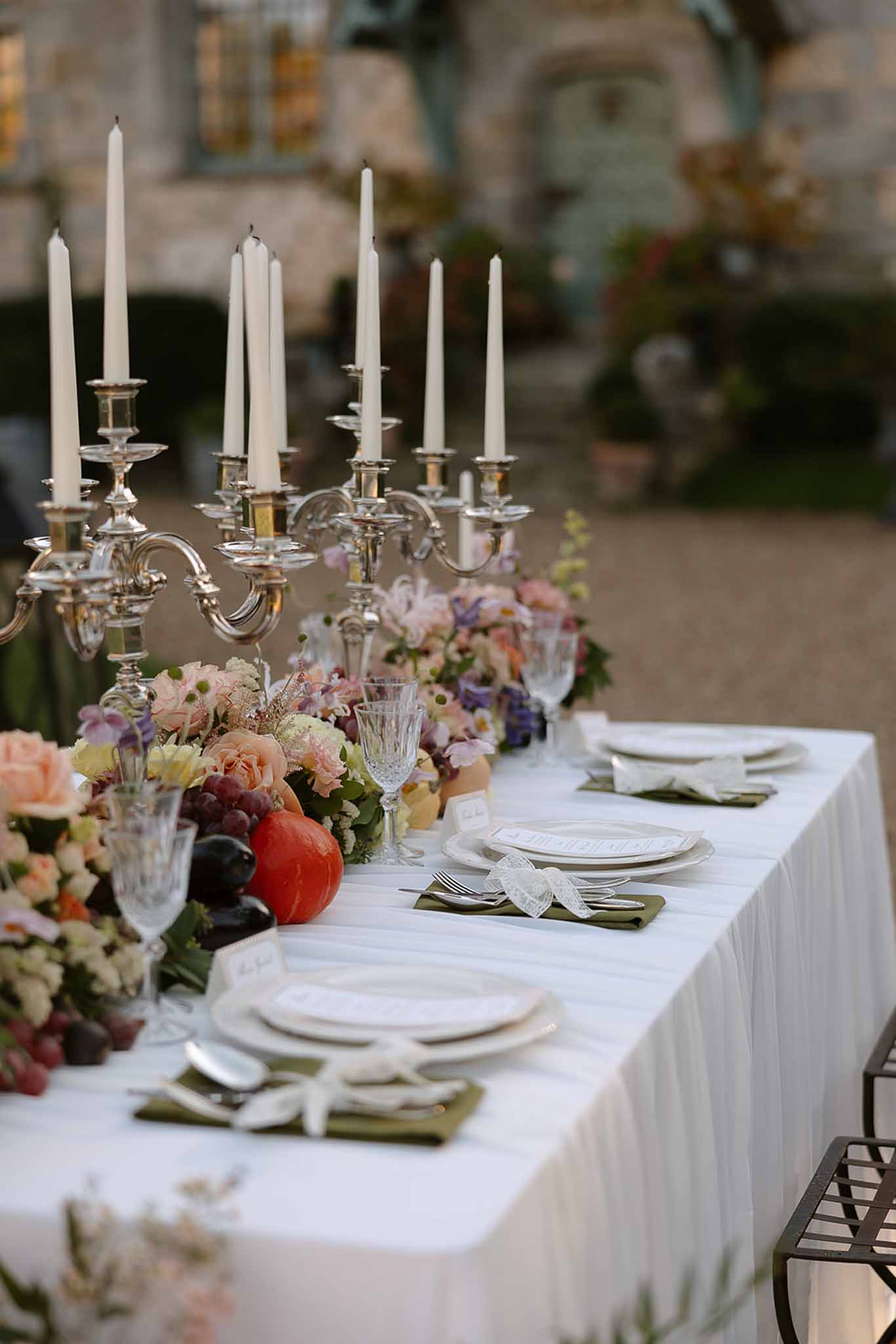 Wedding reception table setting in a garden with white roses
