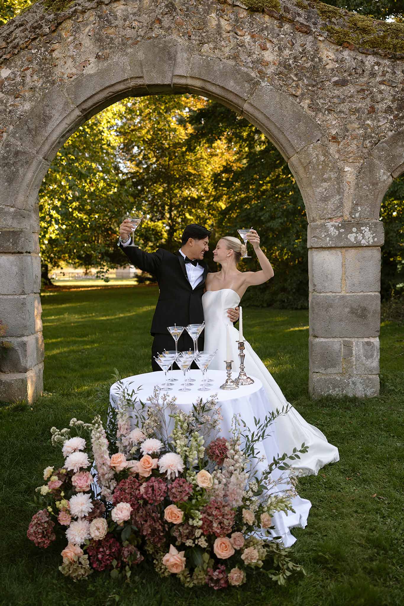 Wedding reception table setting in a garden with white roses