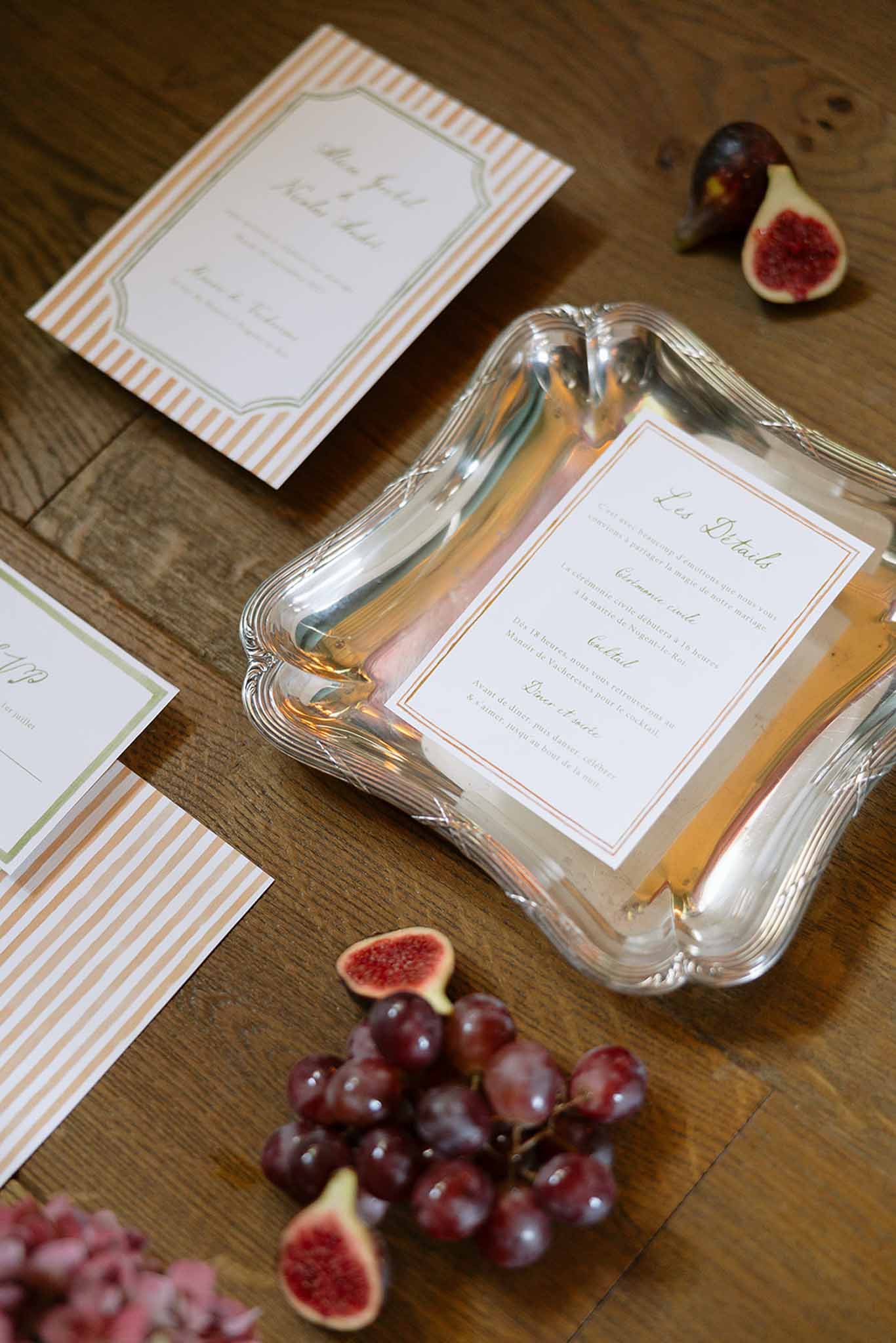 French wedding stationery suite with orange stripe border and green script on silver tray with figs and grapes