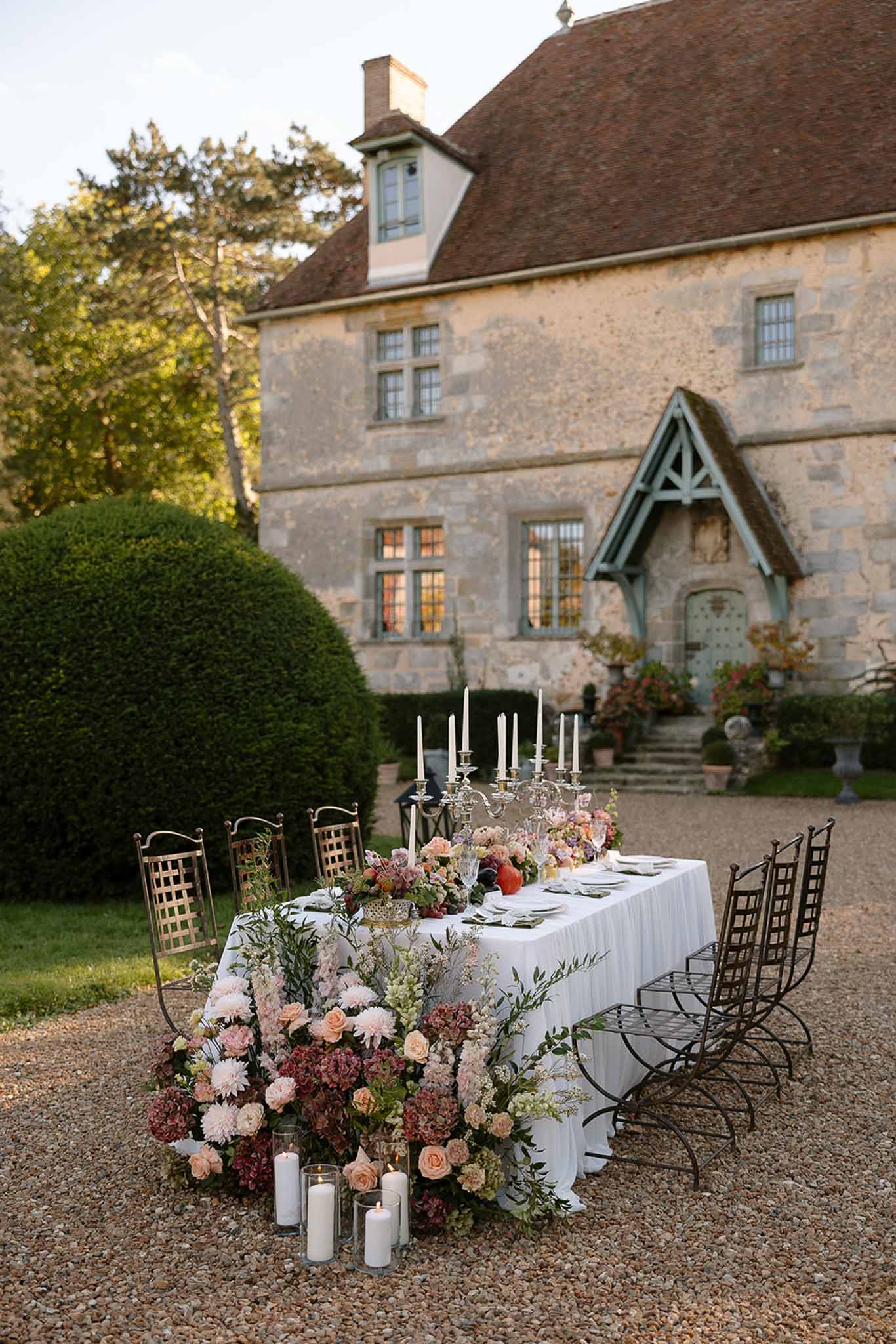 Wedding reception table setting in a garden with white roses