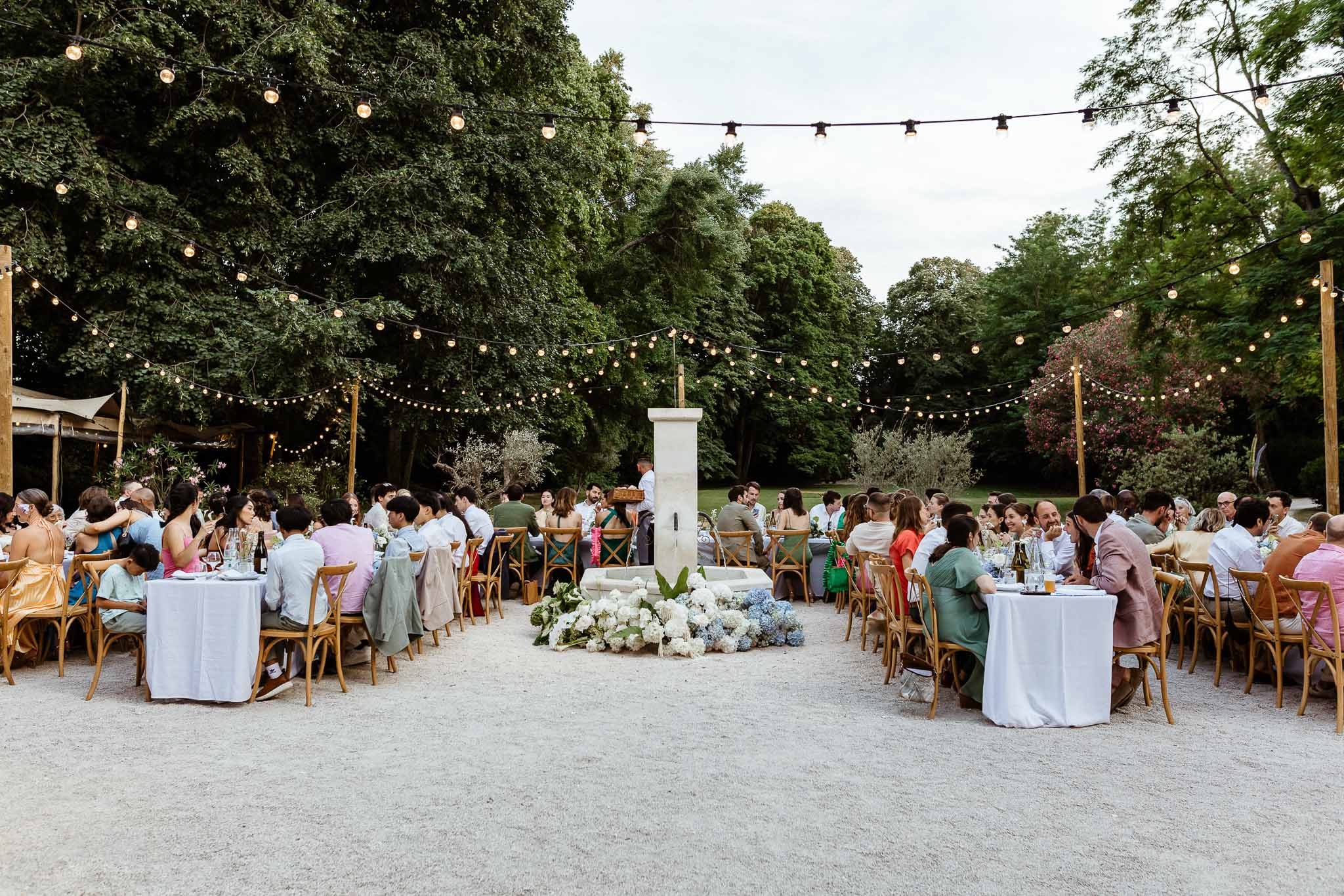 Wedding reception table setting in a garden with hydrangeas