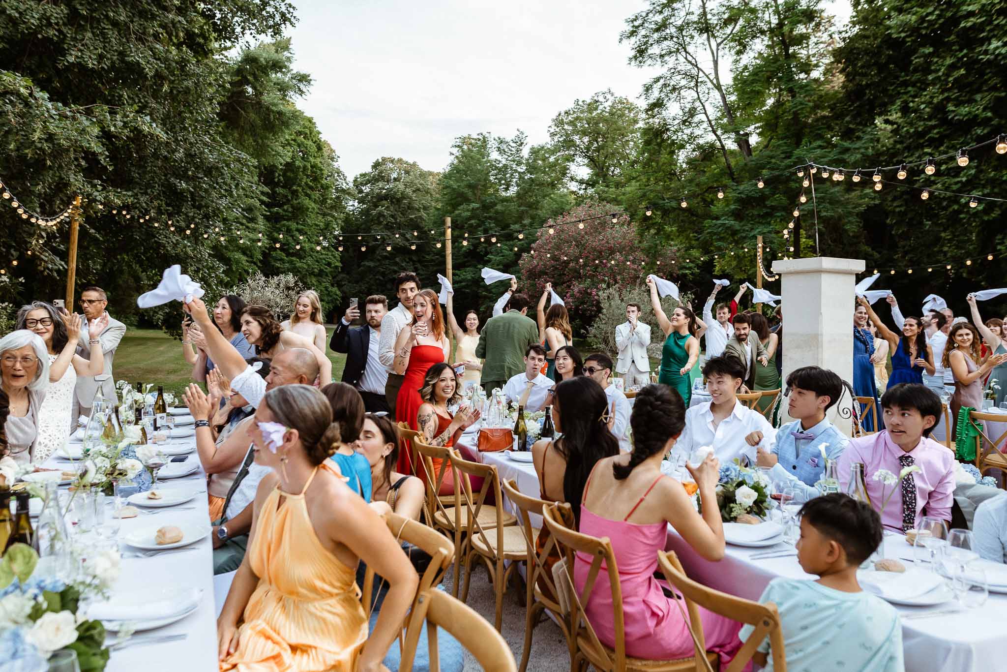 Wedding reception table setting in a garden with hydrangeas