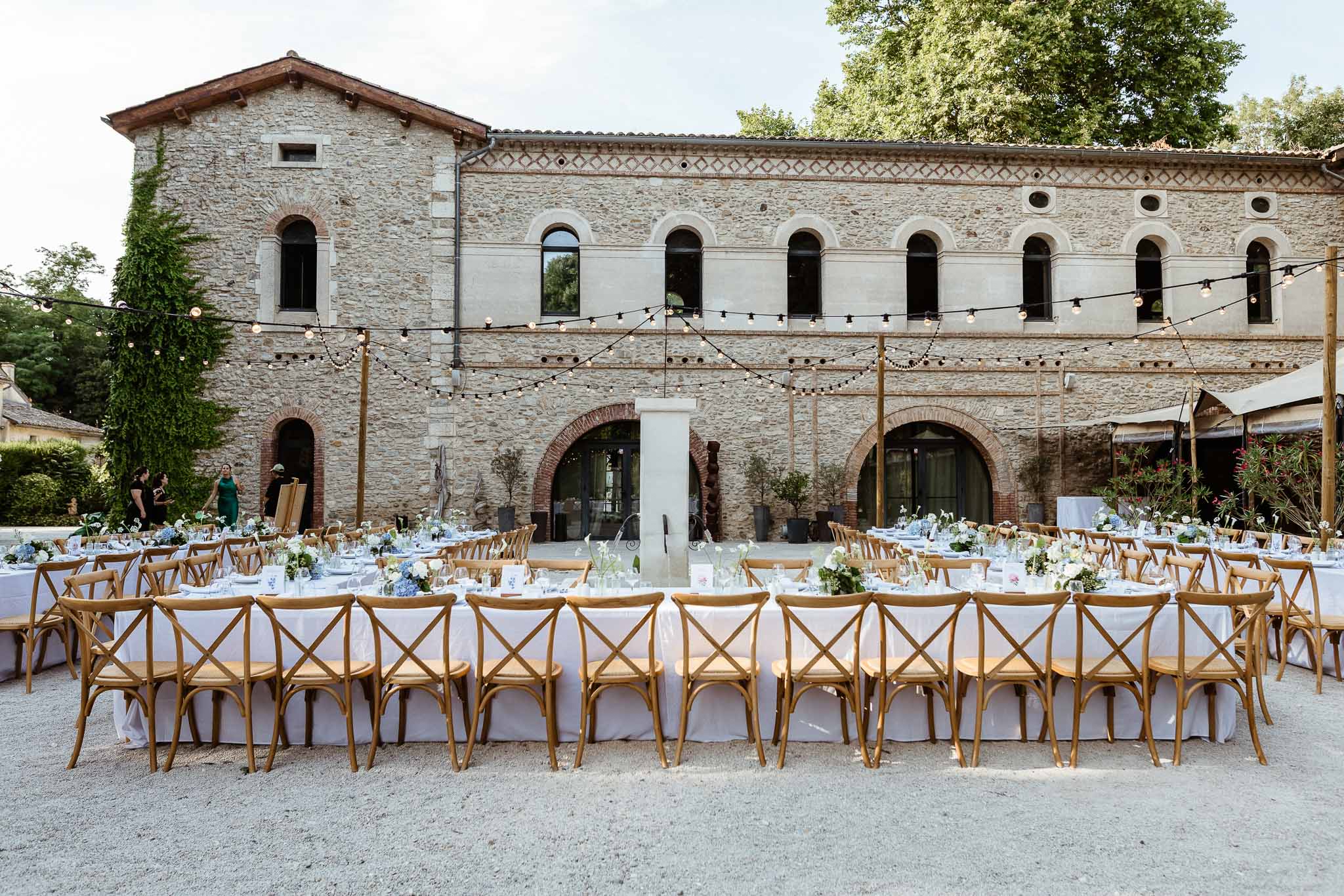 Wedding reception table setting in the French countryside with hydrangeas