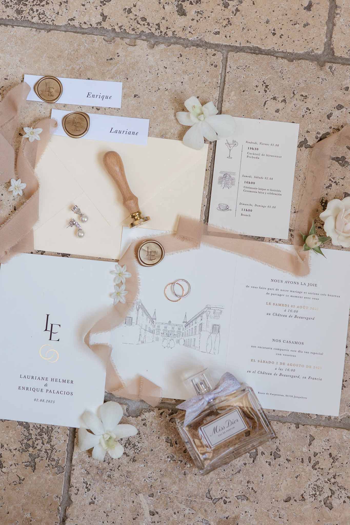 Bilingual stationery suite with chateau sketch, gold wax seals, Miss Dior, and orchid on terracotta