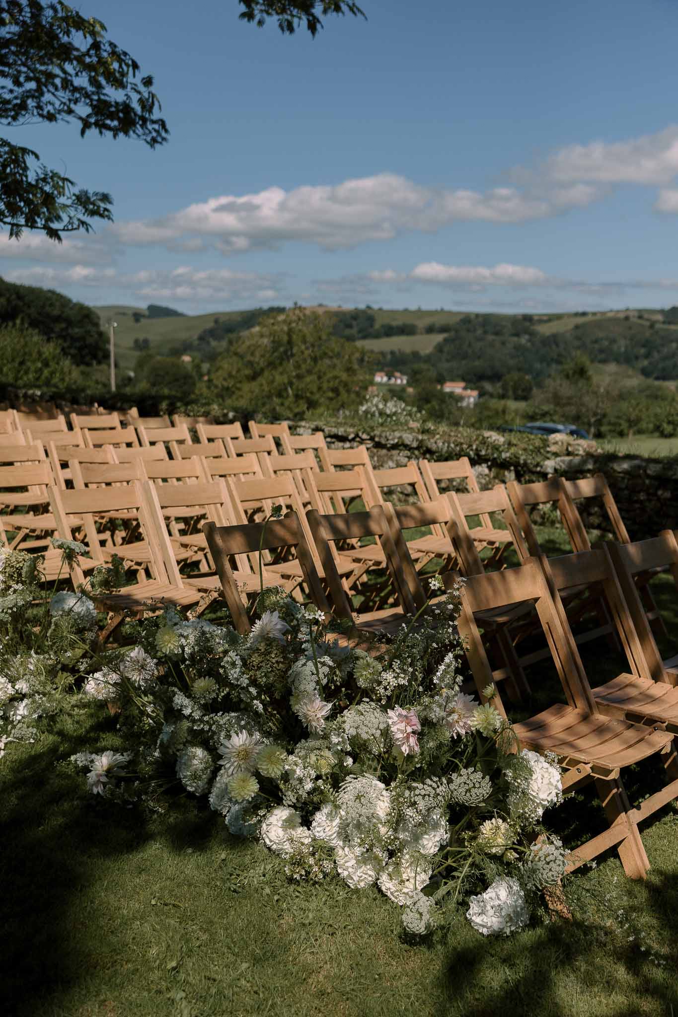 Wedding ceremony setup in a garden with white roses