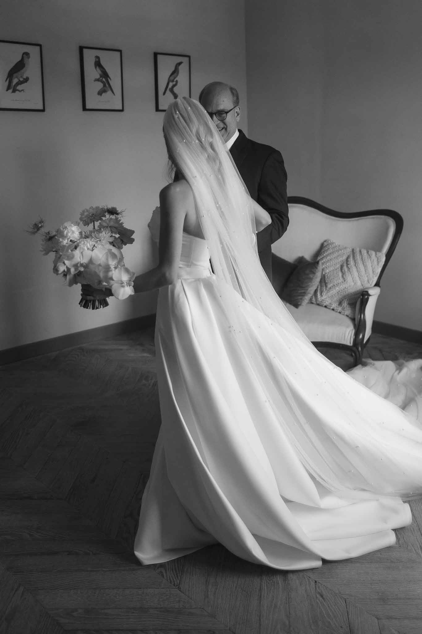 Black and white photo of first look between bride and groom in a garden