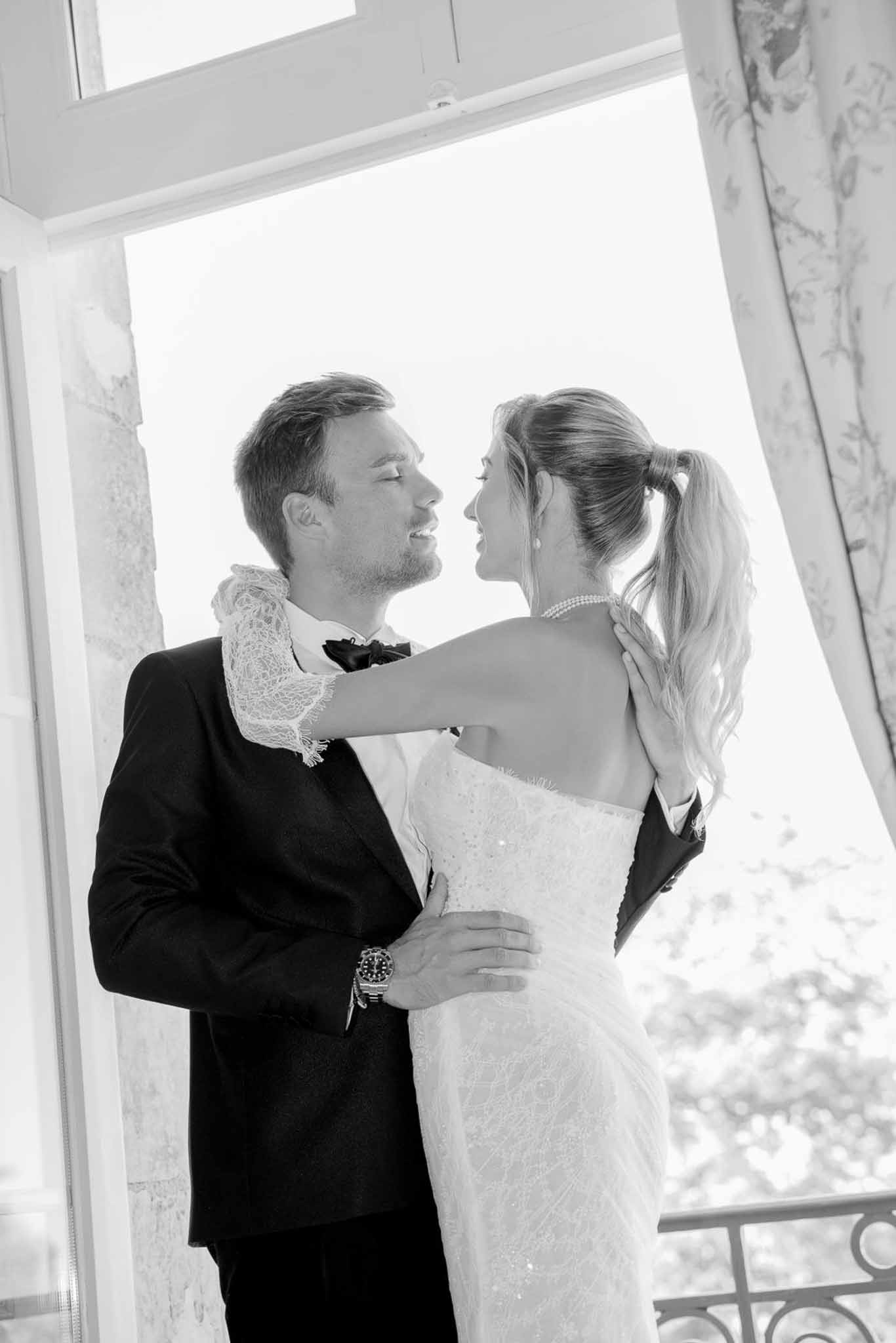 Black and white photo of bride and groom kissing