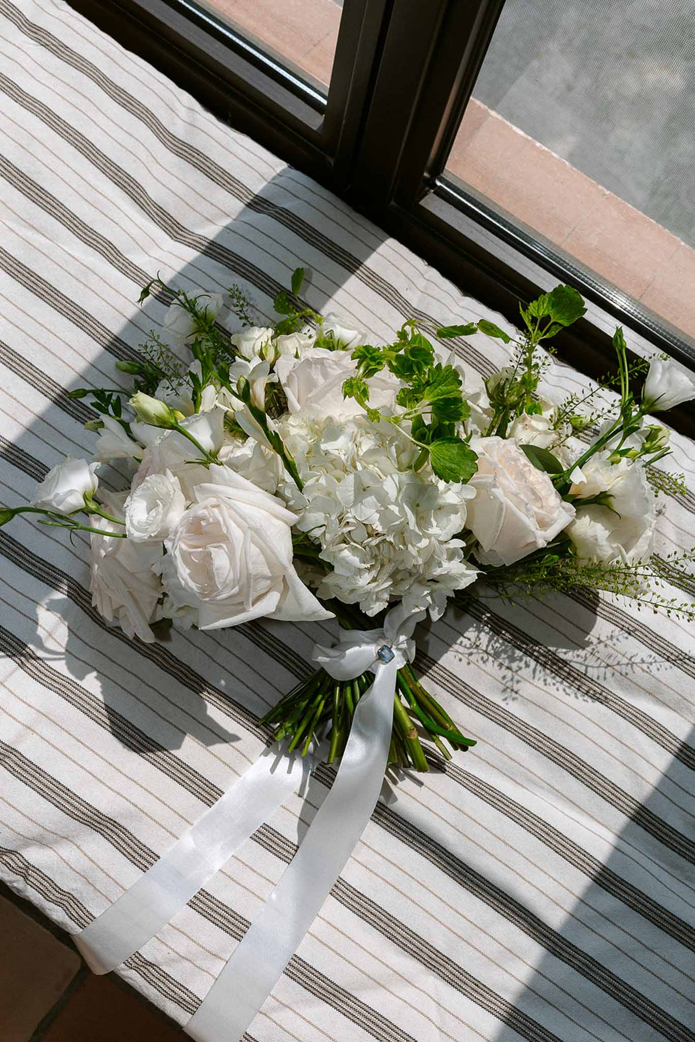 Wedding bouquet in a garden with white roses