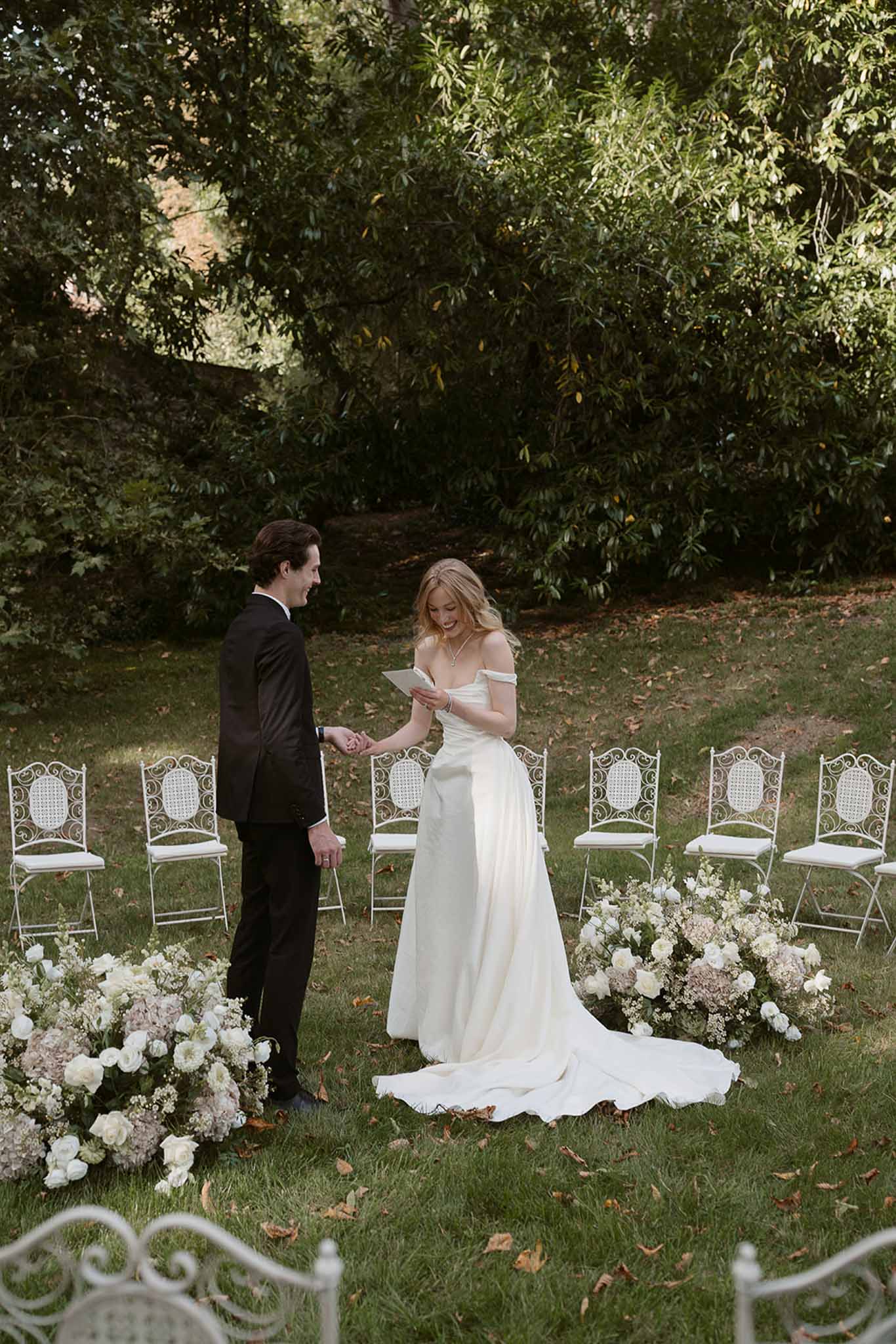 Wedding ceremony setup in a garden with white roses